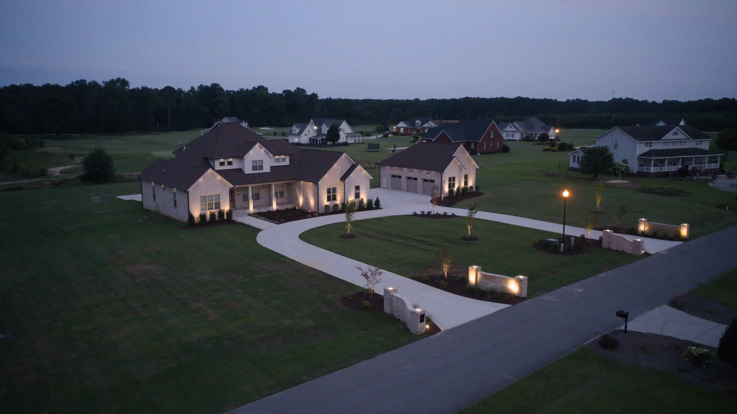 Aerial view of suburban homes at dusk with lights in raleigh north carolina.