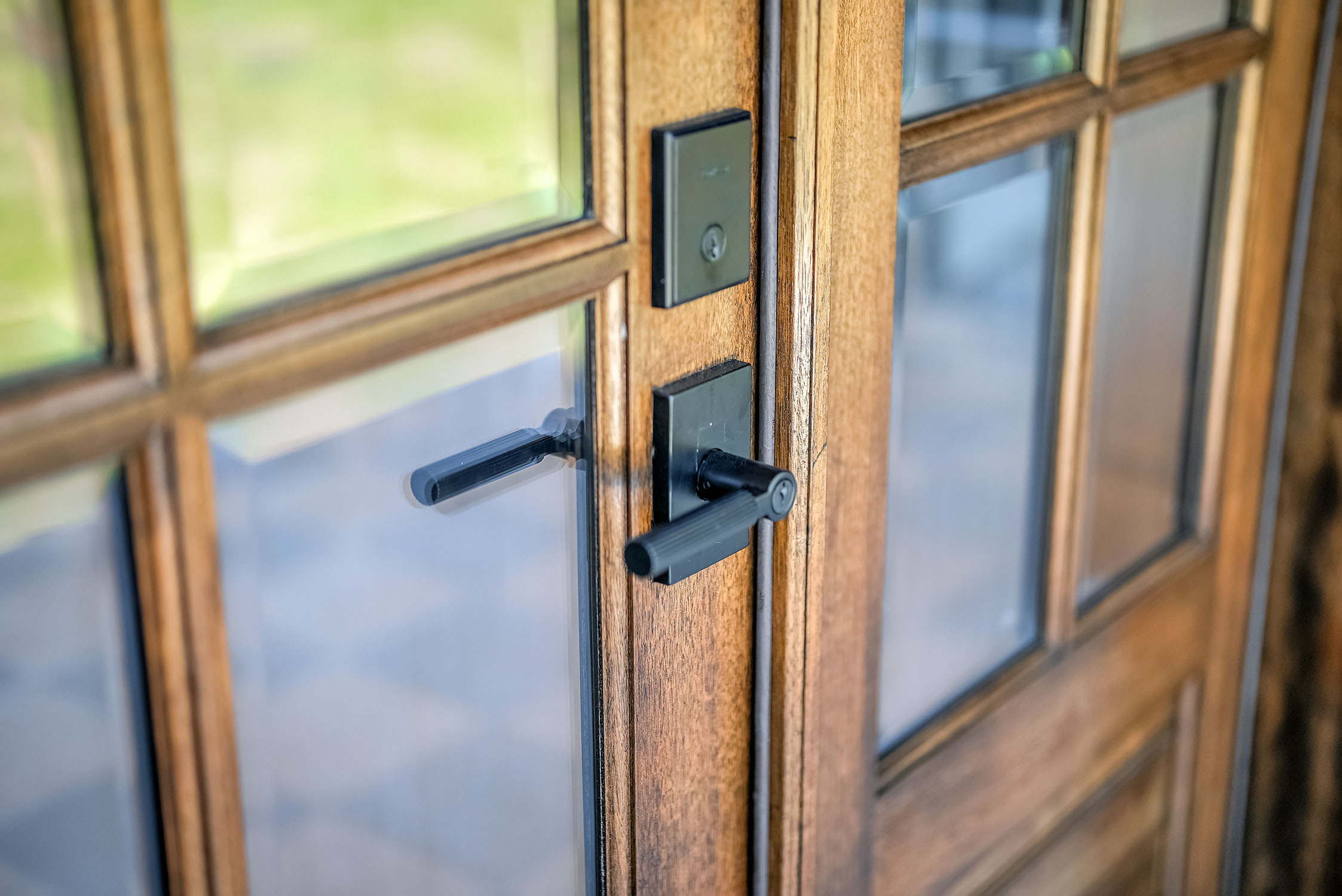 Close-up of wooden French doors with black handles