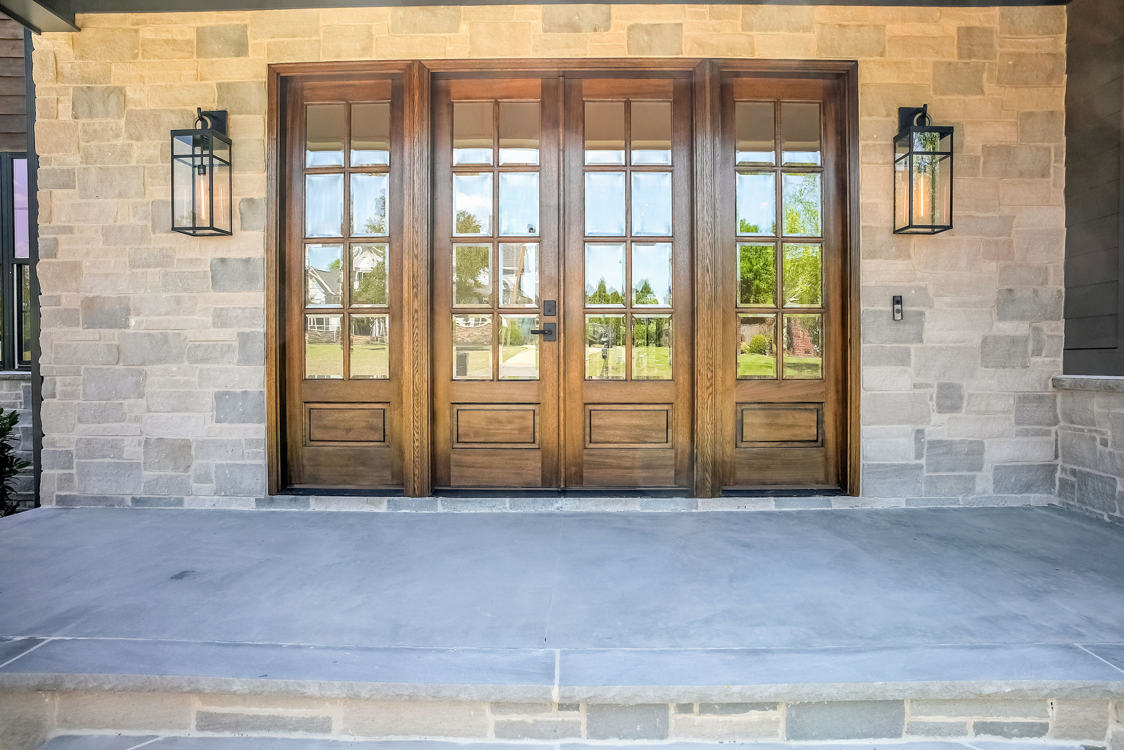 Wooden double front doors with glass panels
