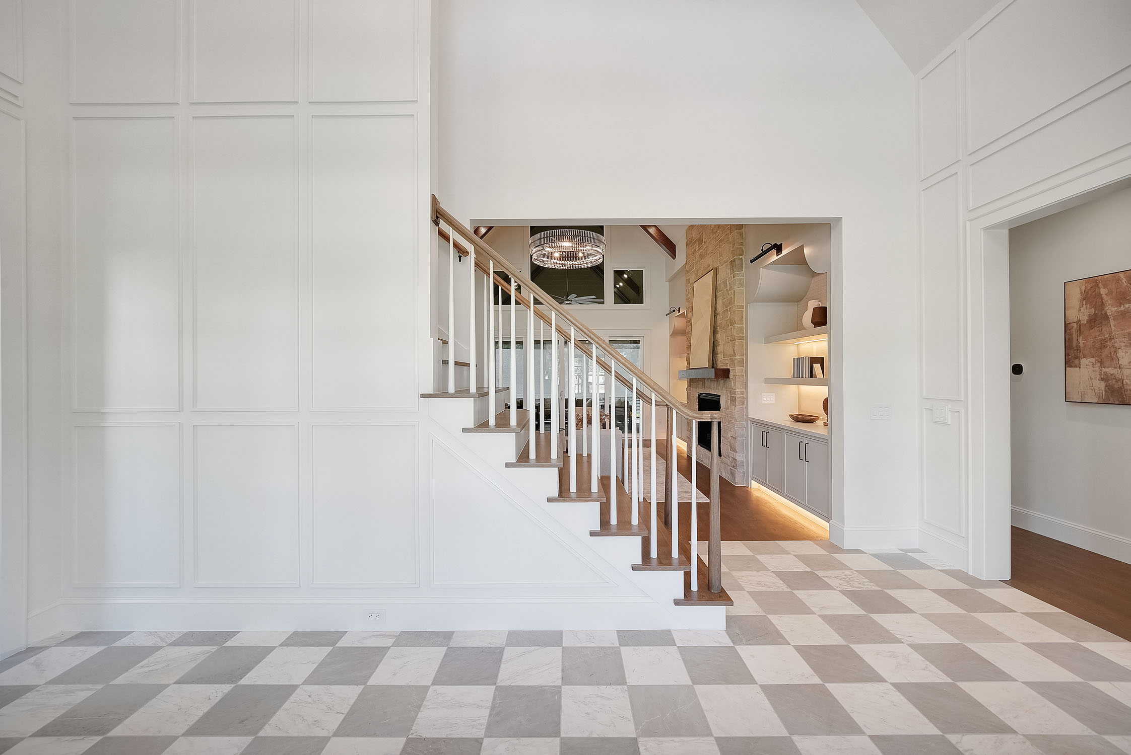 Modern foyer with staircase and checkered marble floor