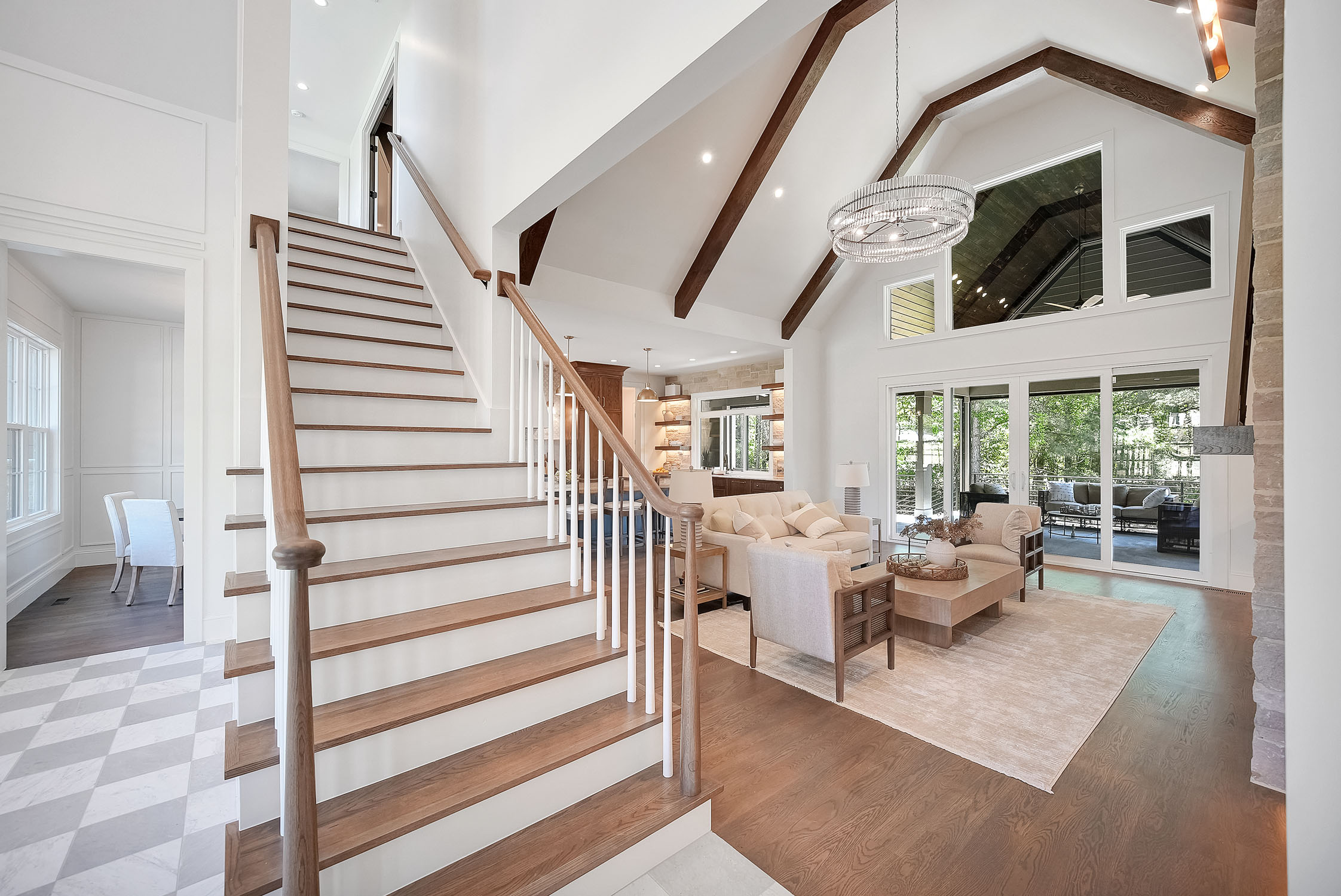 Modern living room with staircase and vaulted ceiling