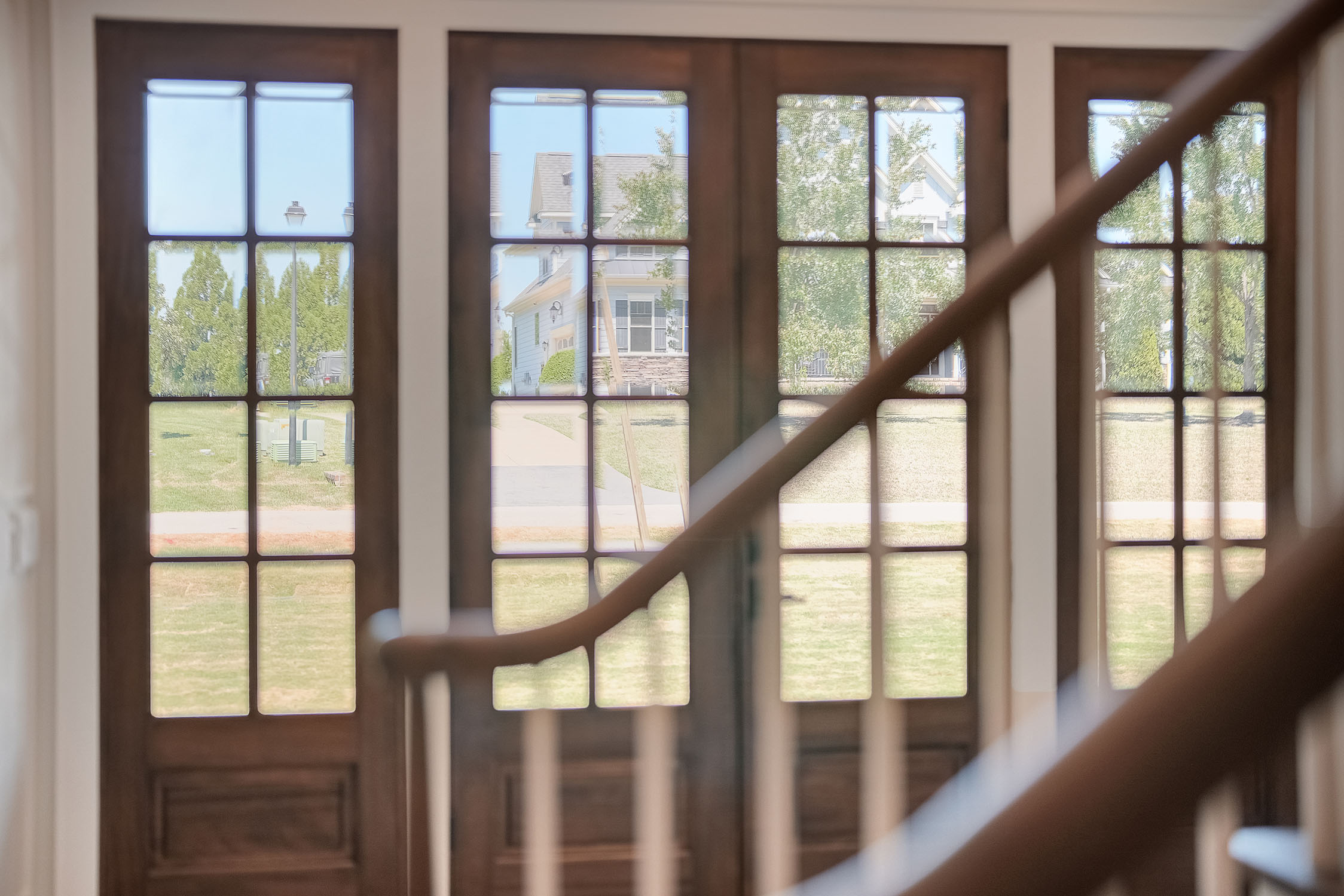 Wooden glass doors overlooking suburban neighborhood