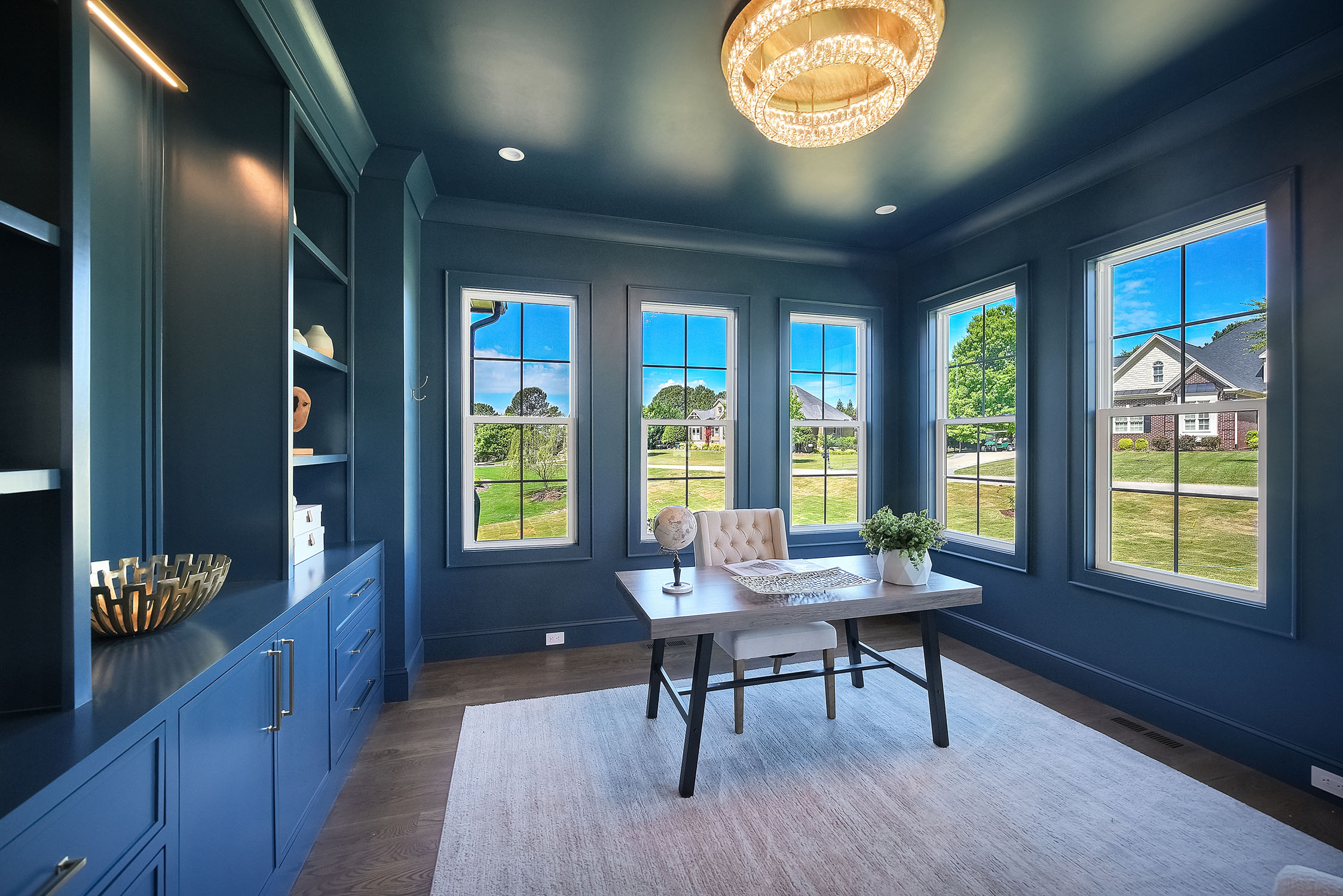 Modern blue home office with large windows