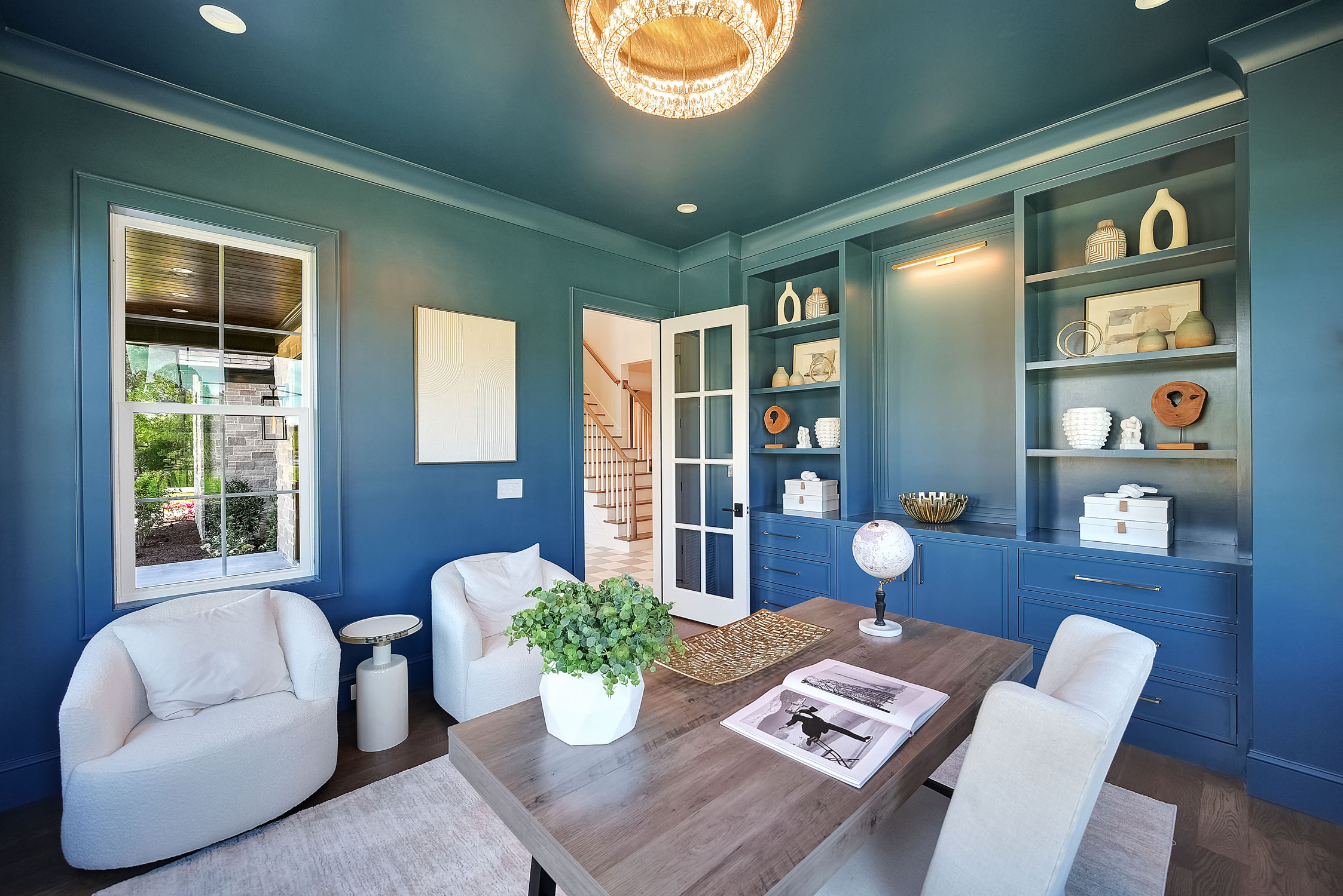 Blue home office with built-in shelves and desk