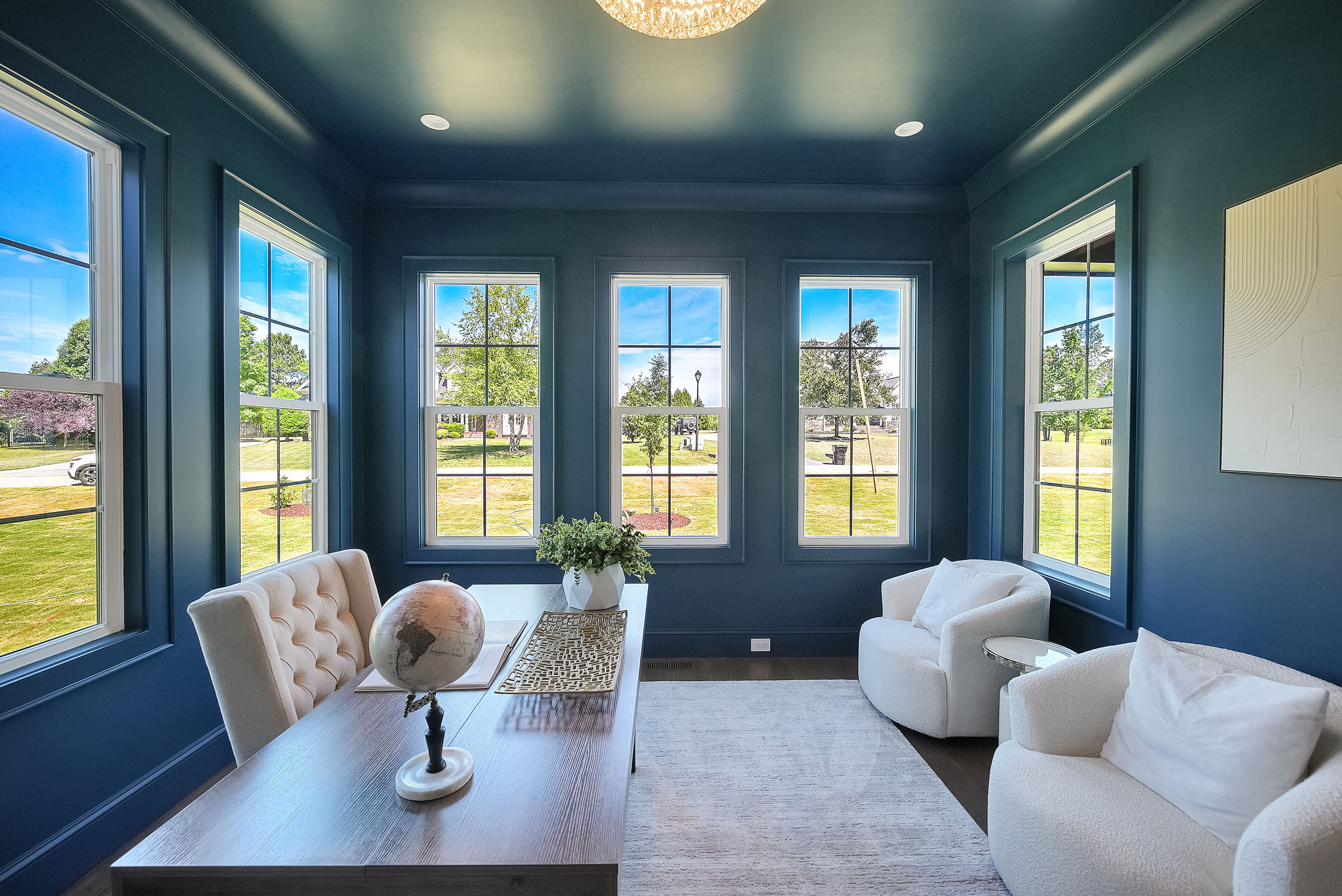 Modern blue home office with large windows