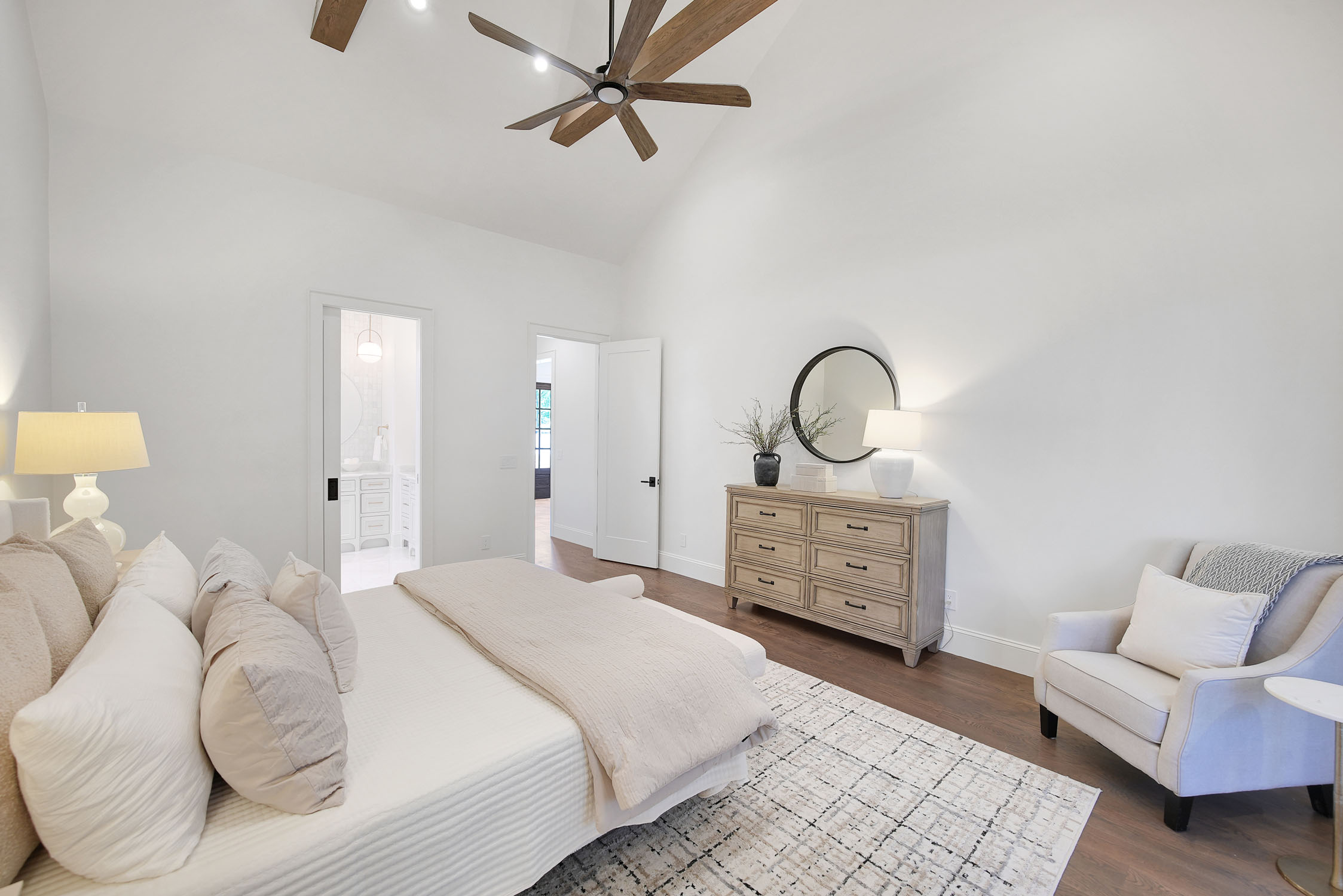Modern neutral bedroom with dresser and ceiling fan