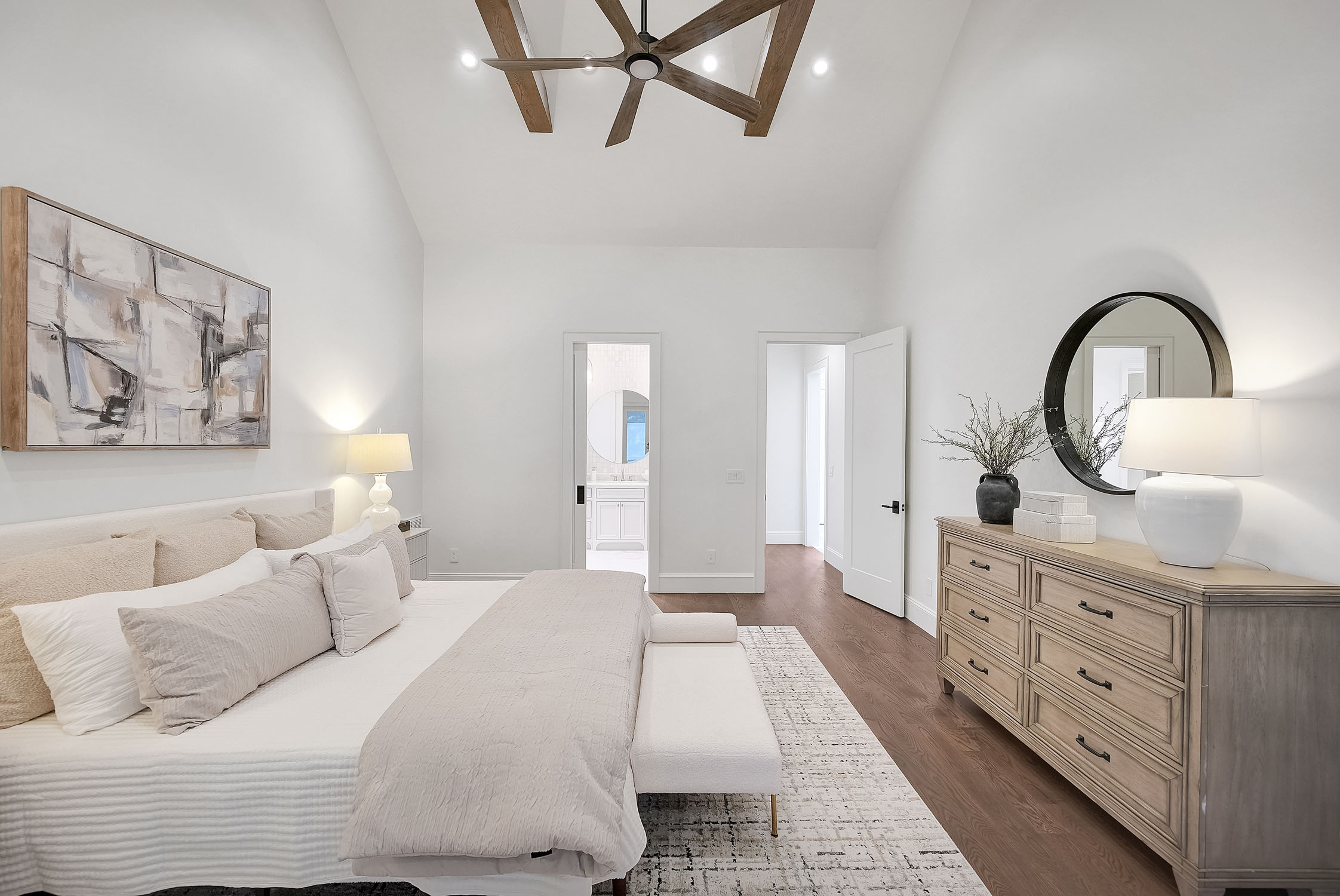 Modern neutral bedroom with vaulted ceiling and dresser