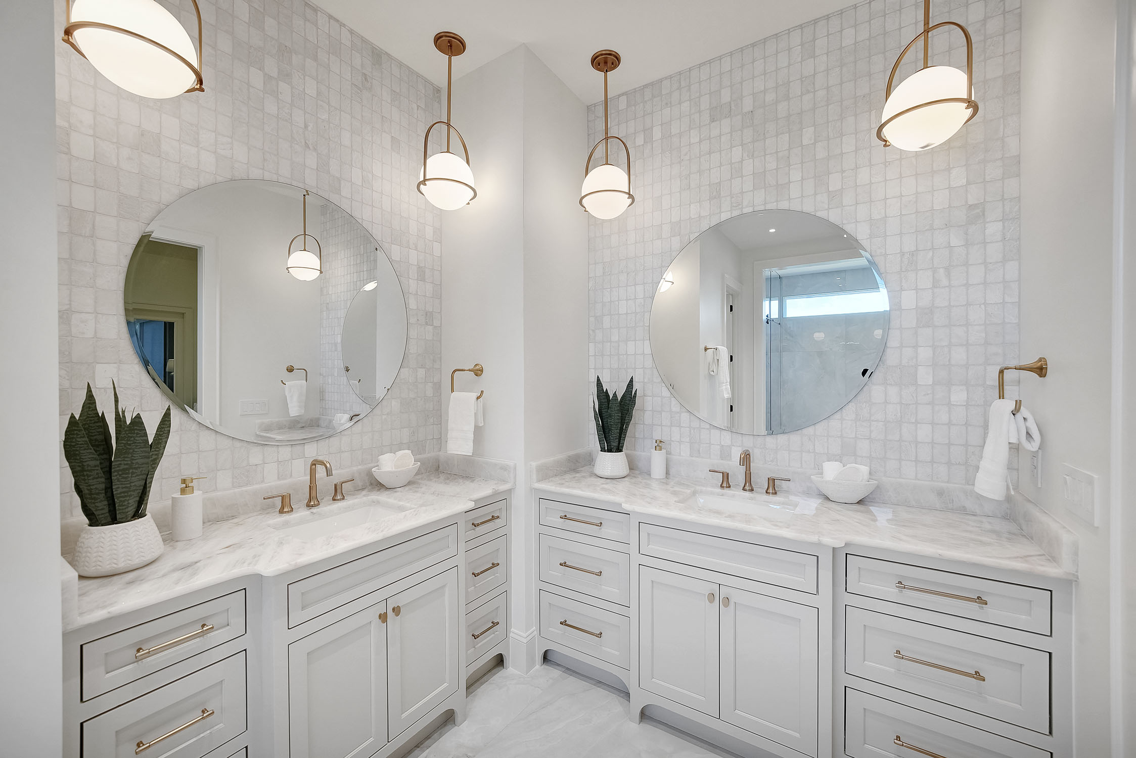 Modern white bathroom with double vanity and round mirrors