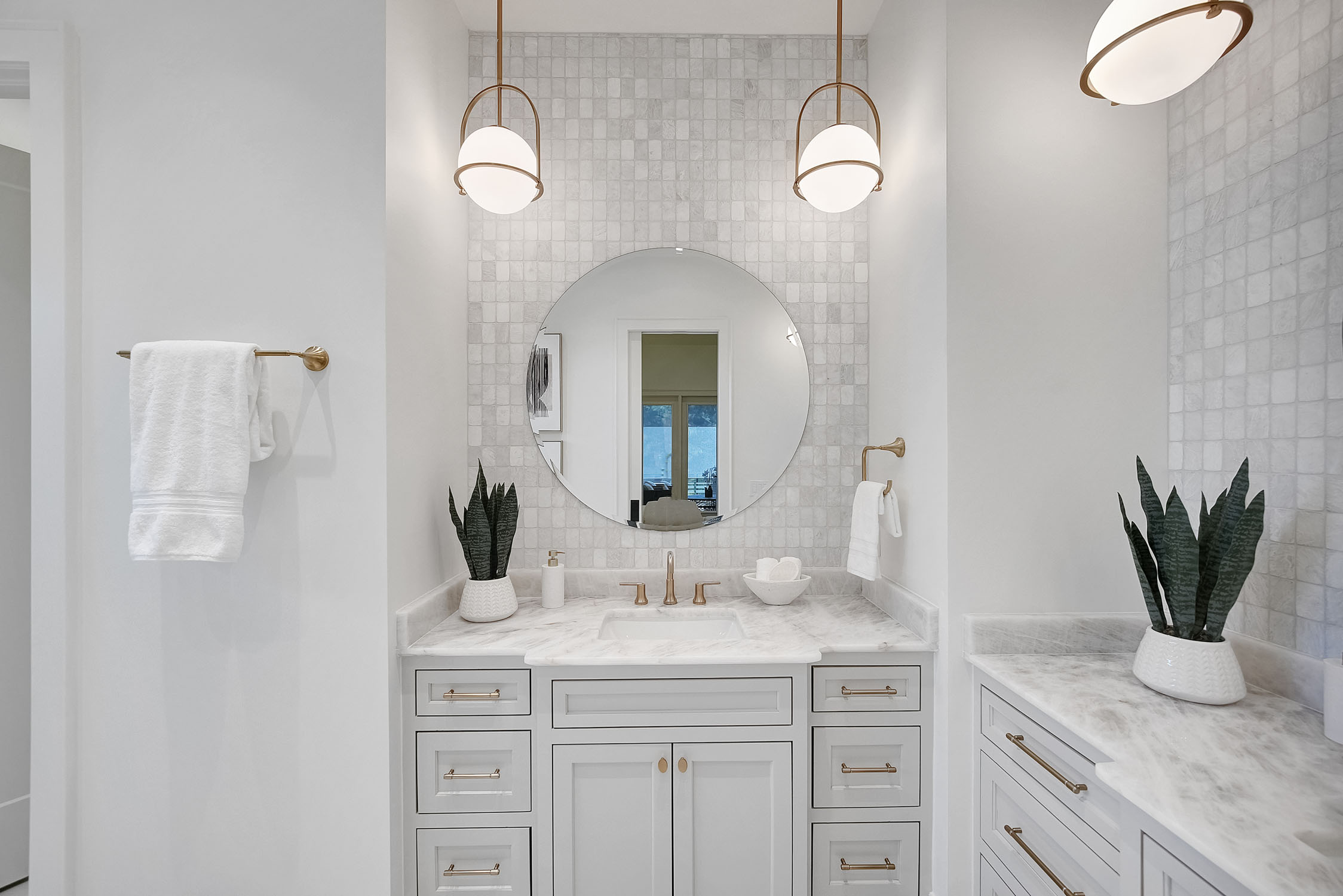 Modern white bathroom vanity with round mirror