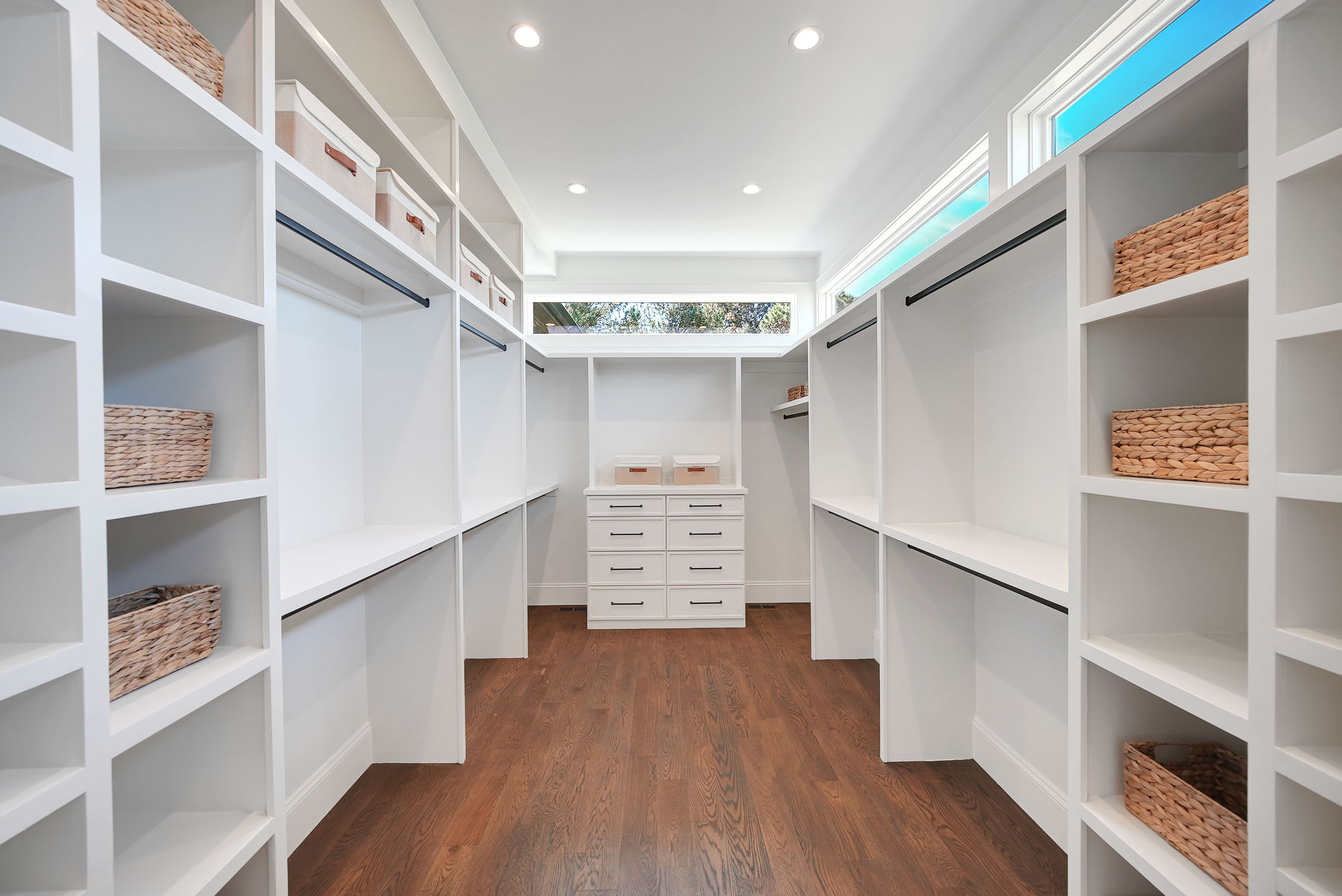 Bright walk-in closet with white built-ins