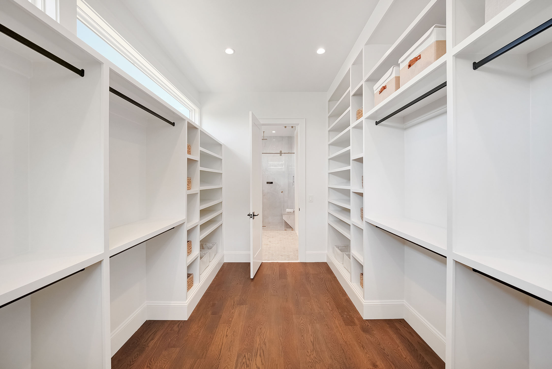 Modern walk-in closet with white built-in shelving