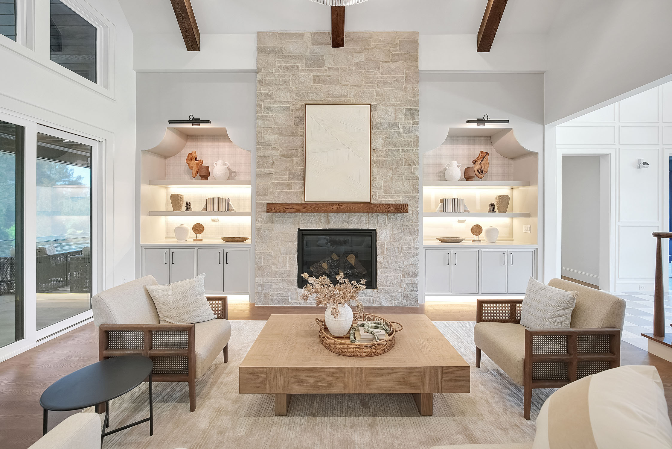 Modern living room with stone fireplace and shelves