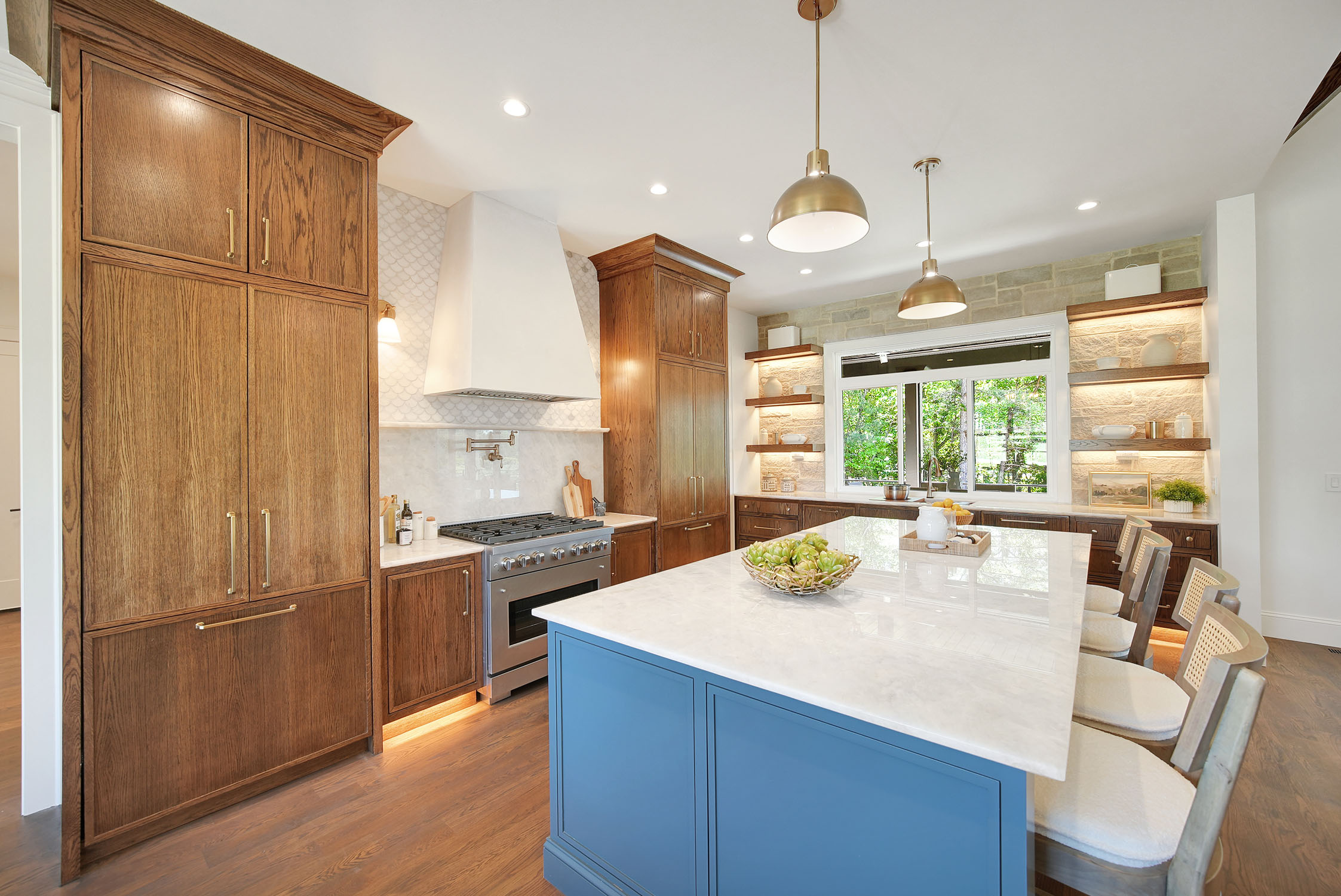Modern kitchen with blue island and wood cabinets