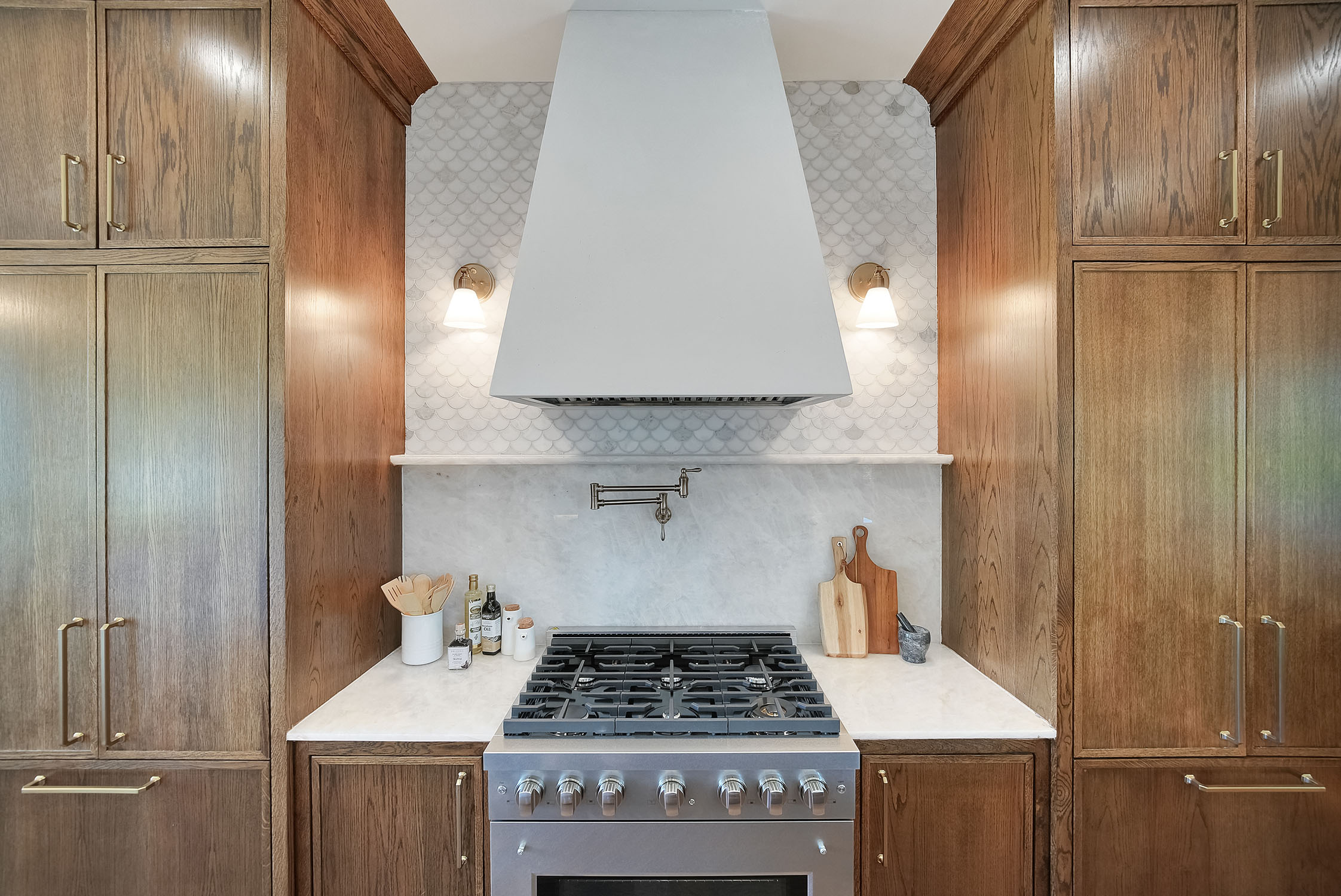 Modern kitchen with wood cabinets and white range hood