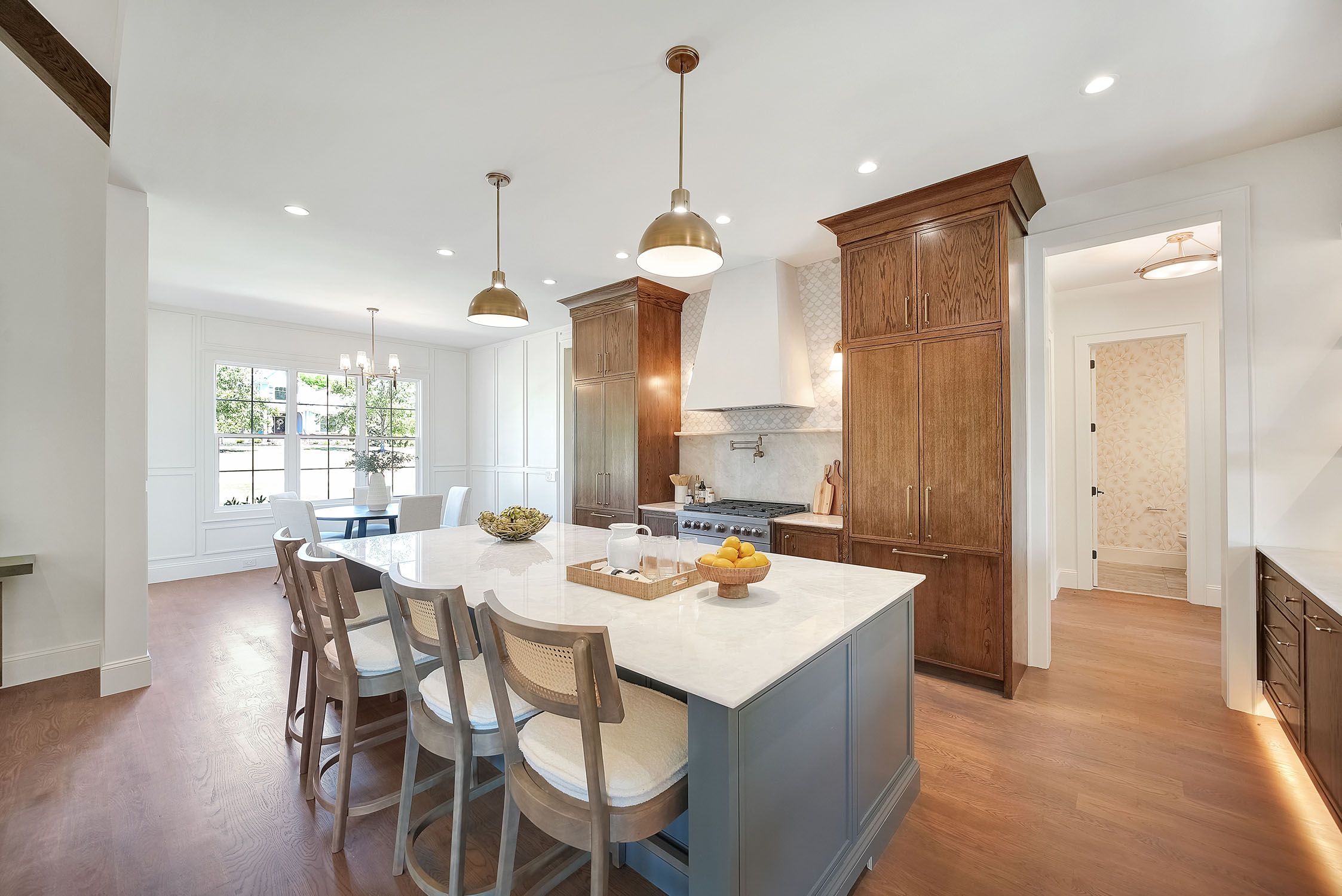 Modern kitchen with marble island and wood cabinets