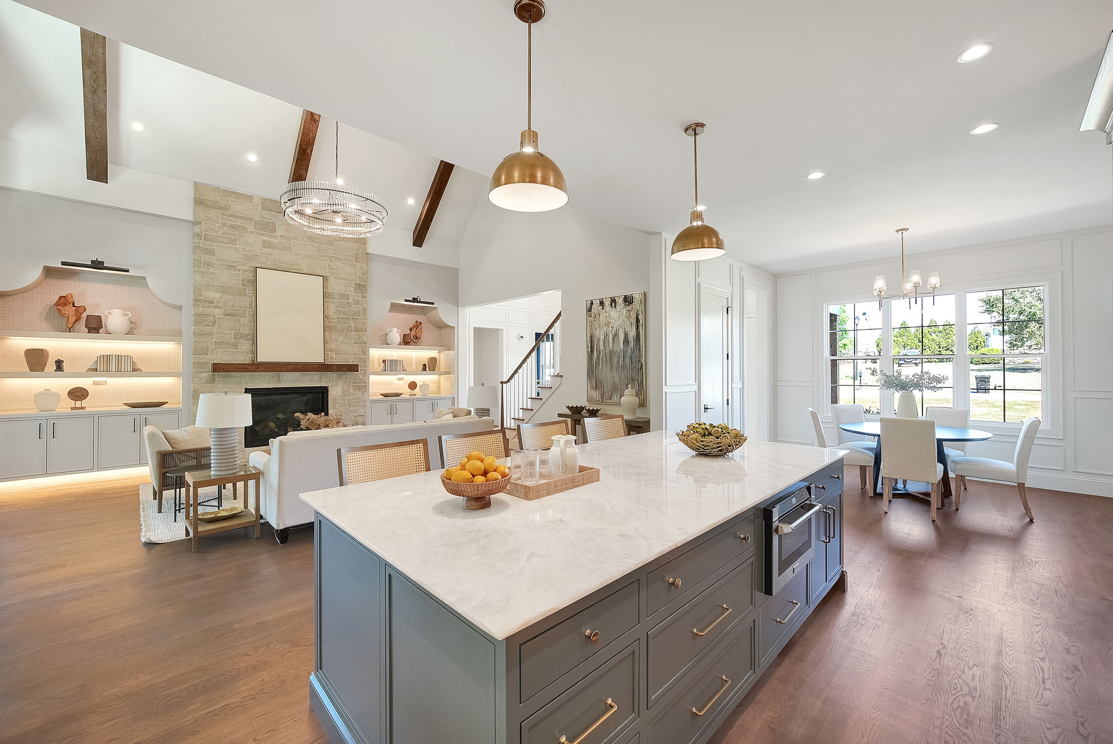 Open-concept kitchen and living room with marble island