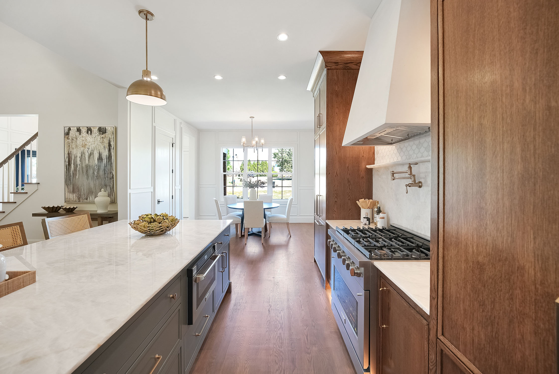 Modern kitchen with marble island and wood cabinets