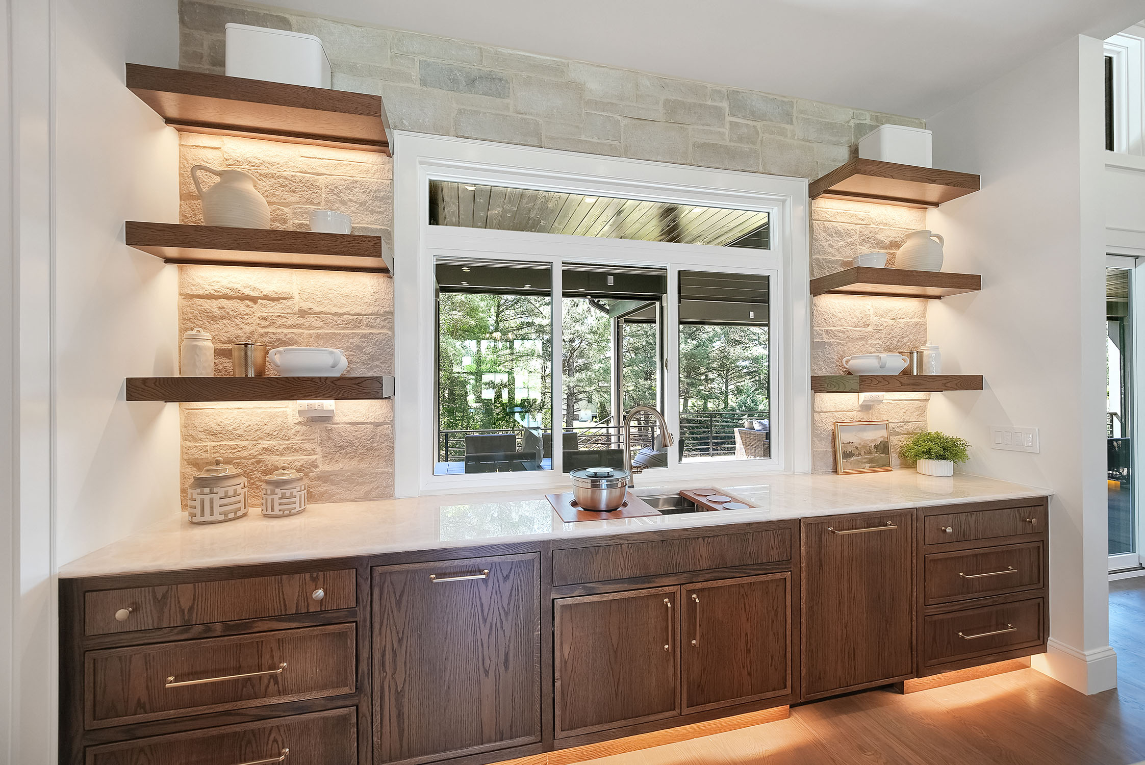 Modern kitchen with stone backsplash and wooden cabinets