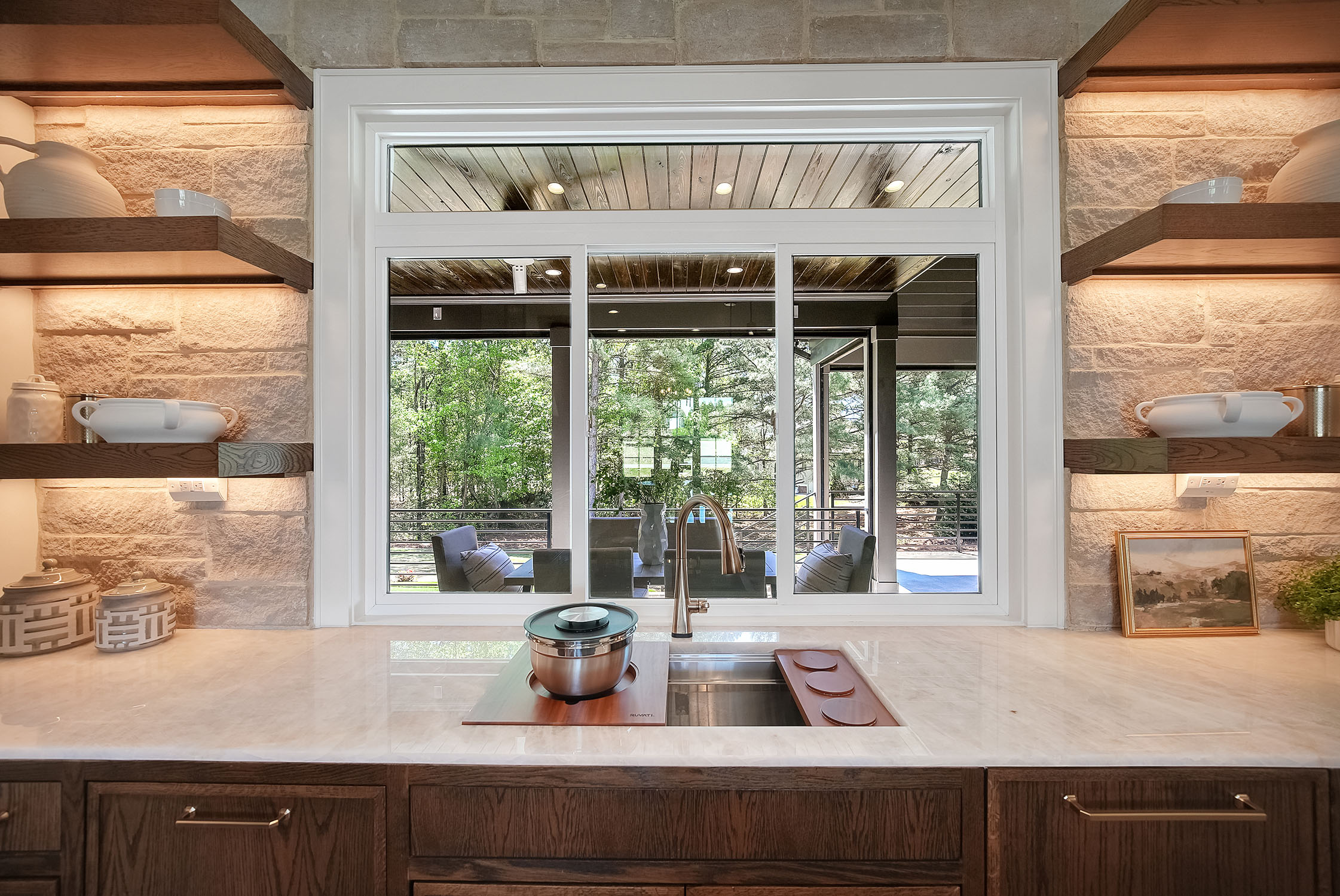 Modern kitchen sink with window overlooking patio