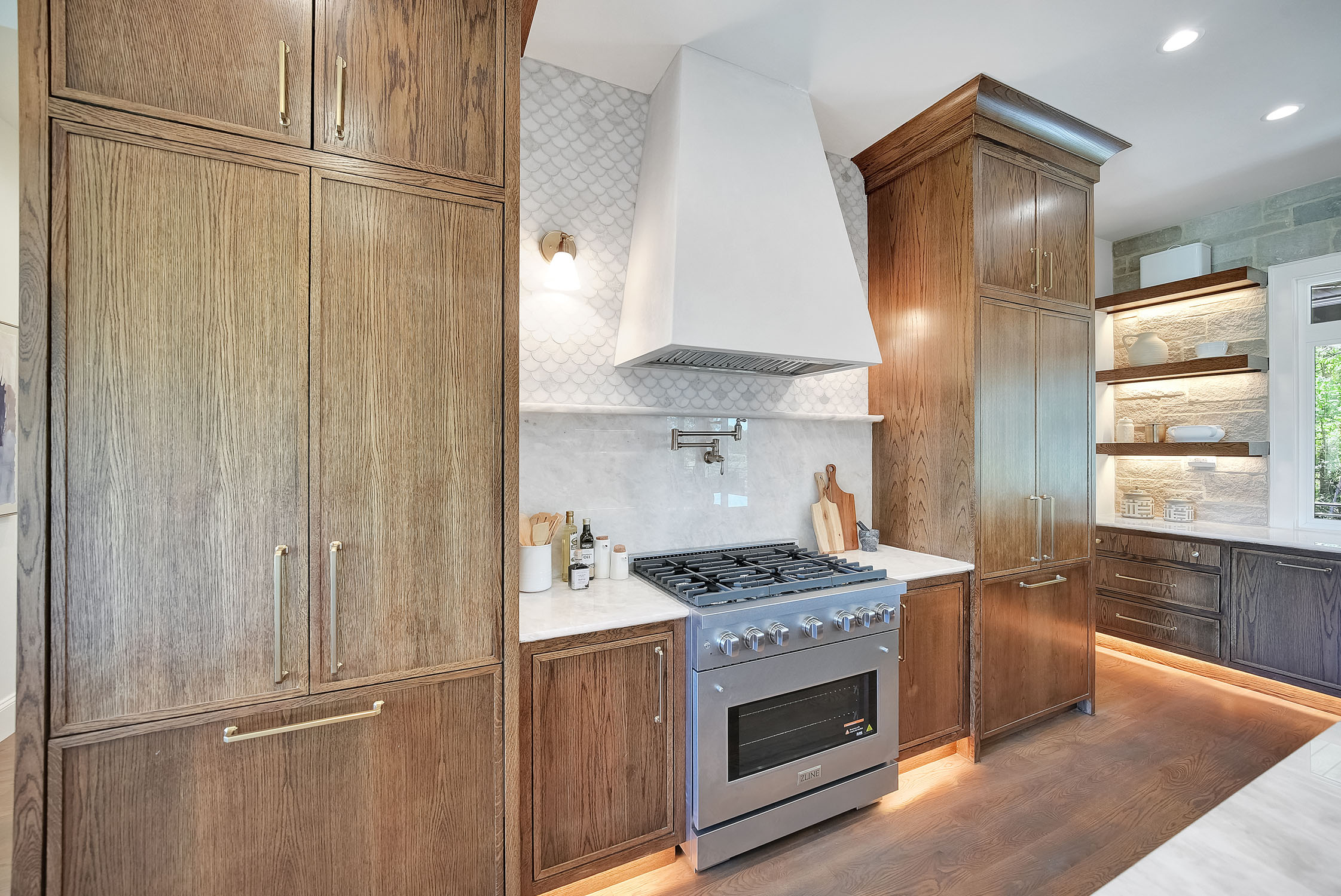 Modern kitchen with wood cabinets and white range hood
