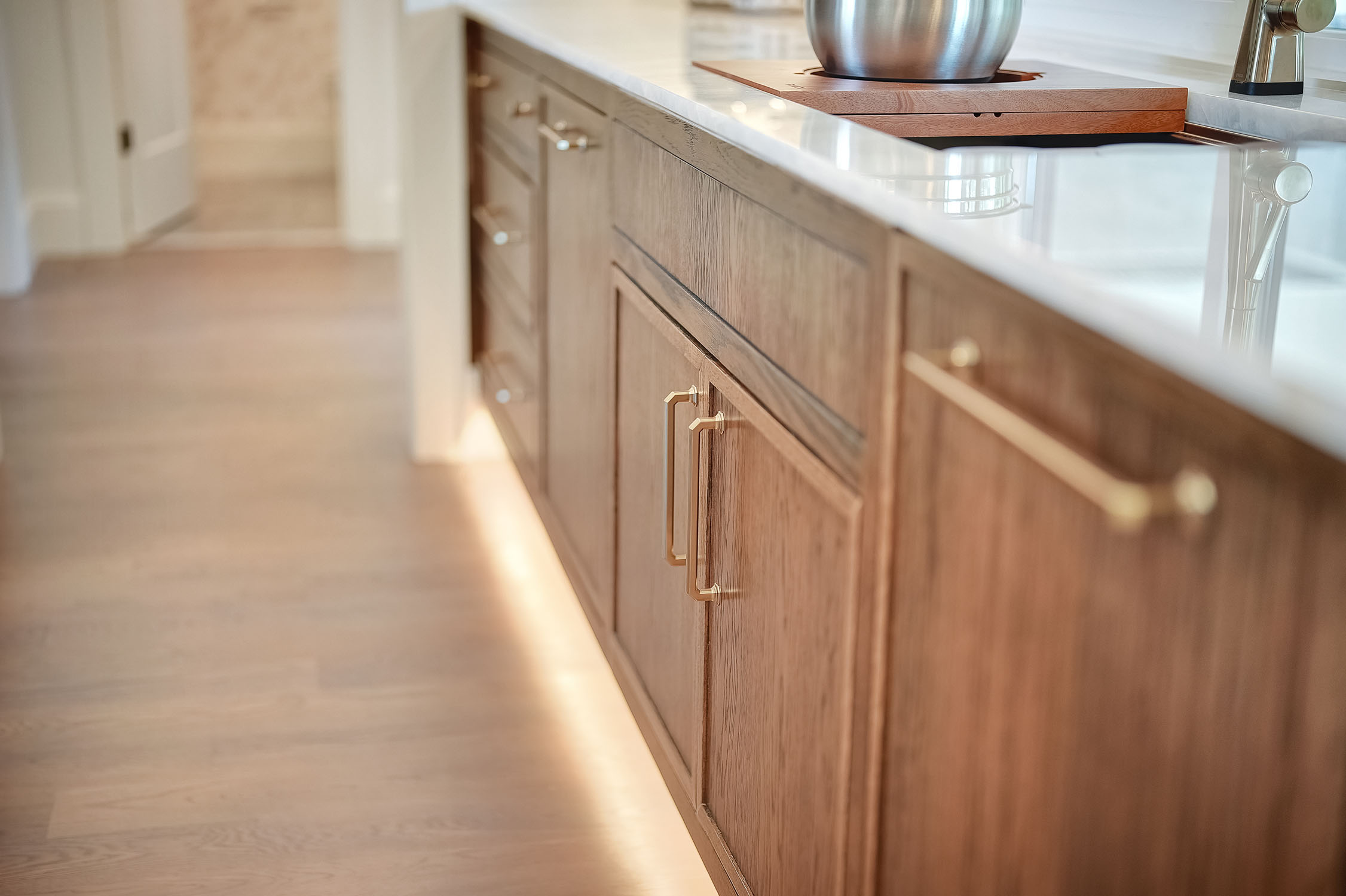 Modern wooden kitchen cabinets with brass handles