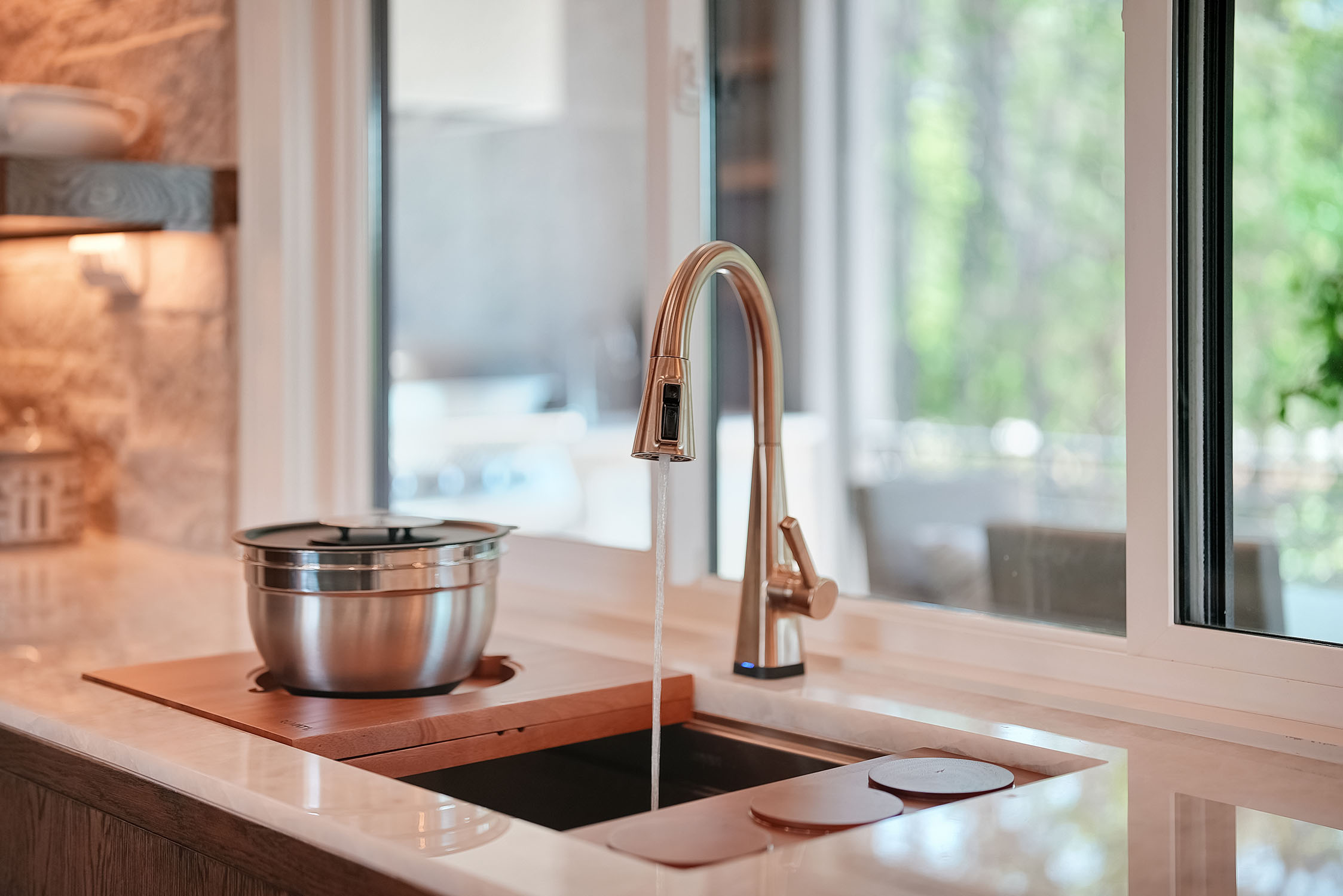 Modern kitchen sink with running faucet and pot