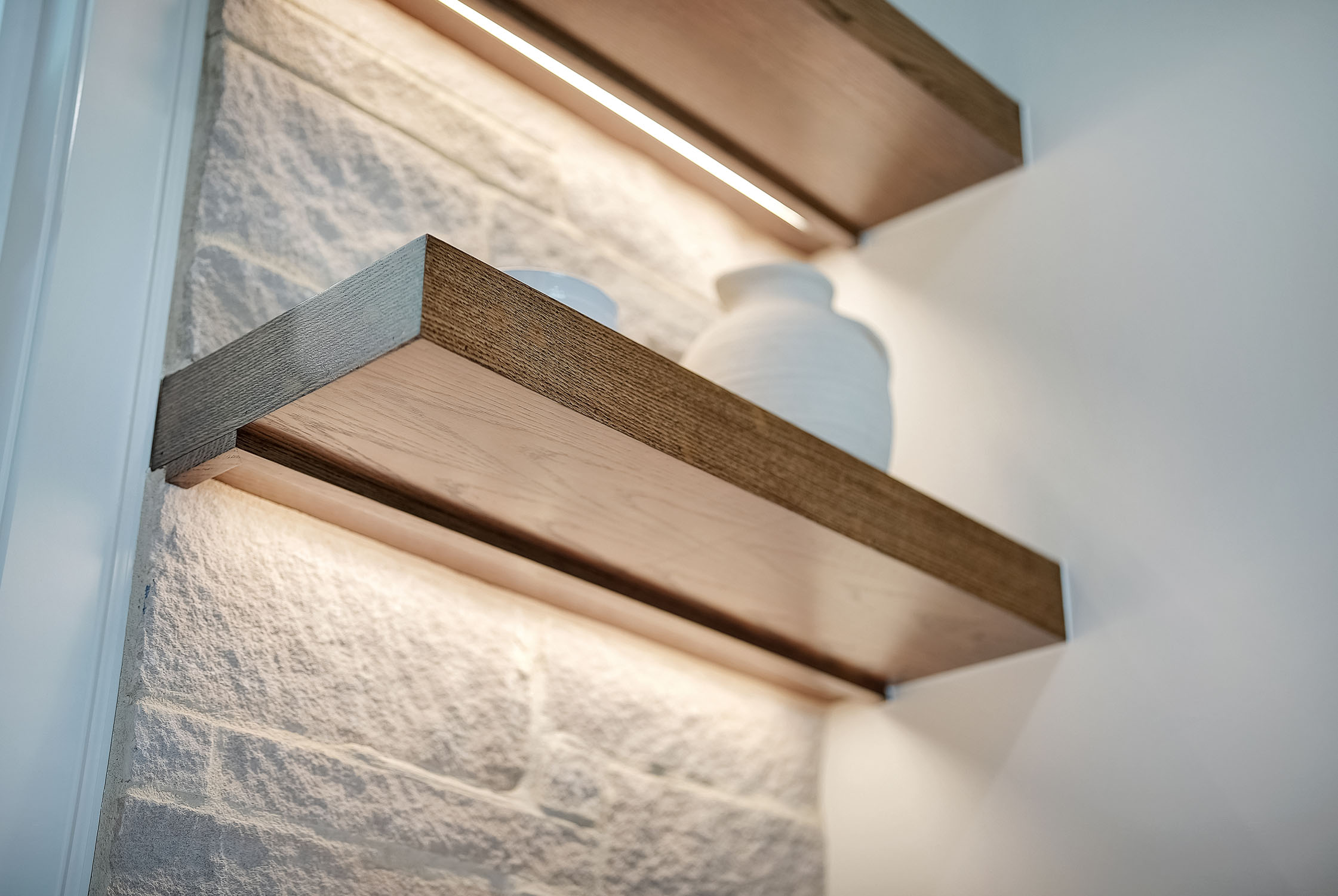 Modern wooden floating shelves with LED lighting