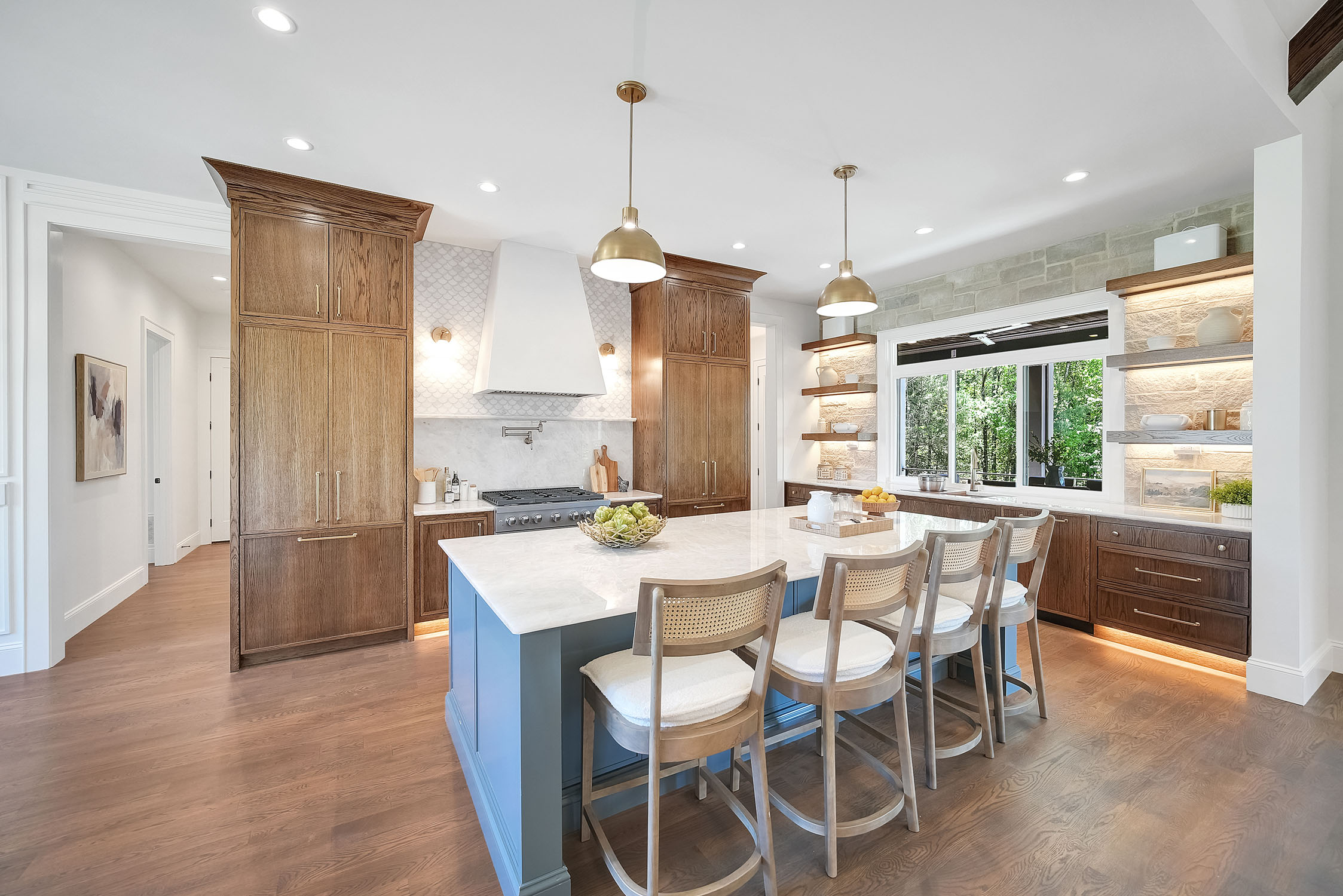 Modern kitchen with blue island and wood cabinets
