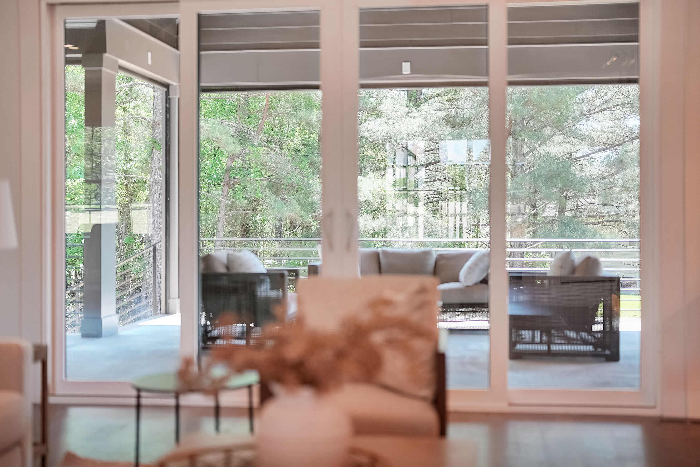Modern living room overlooking patio and trees