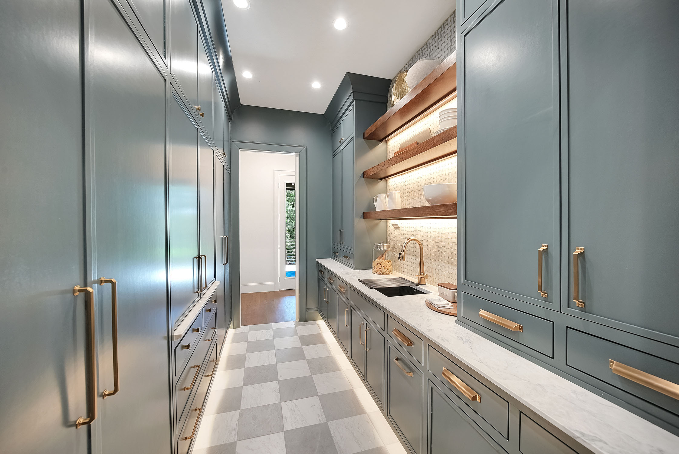 Modern blue butler’s pantry with marble countertop