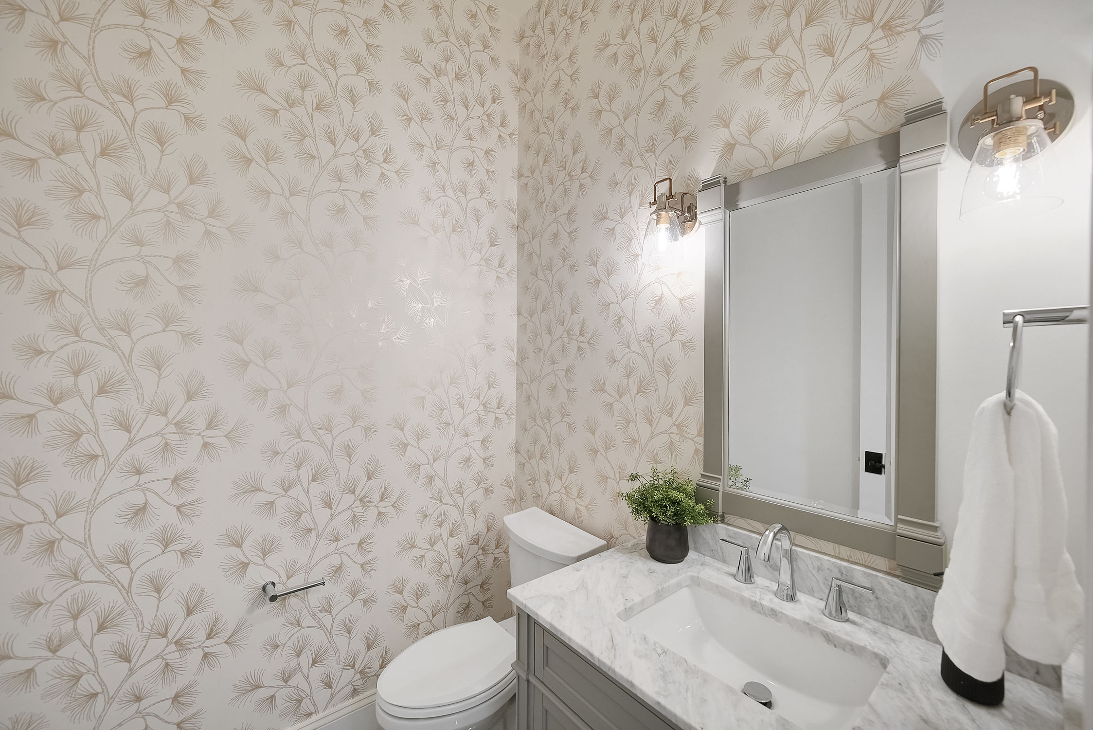 Elegant bathroom with floral wallpaper and marble vanity