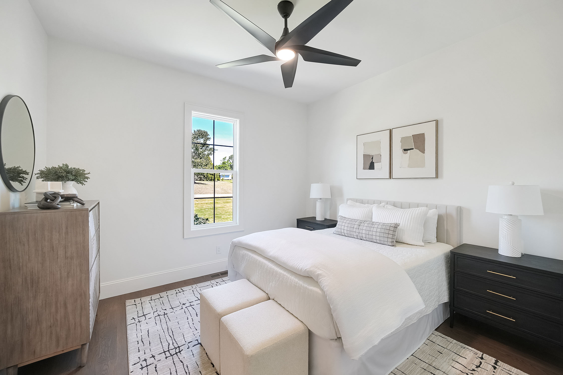 Modern white bedroom with ceiling fan and window