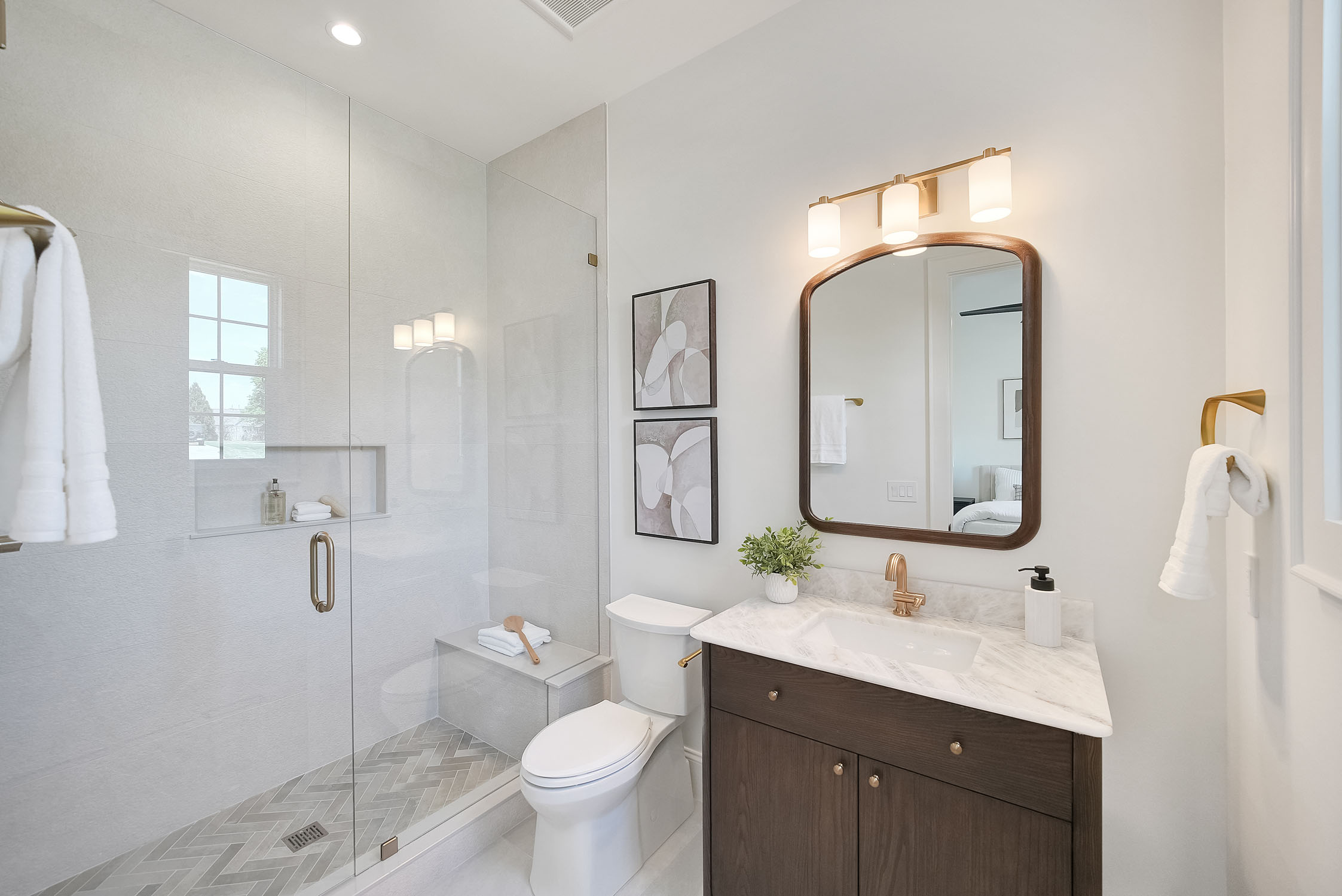 Modern bathroom with glass shower and marble vanity
