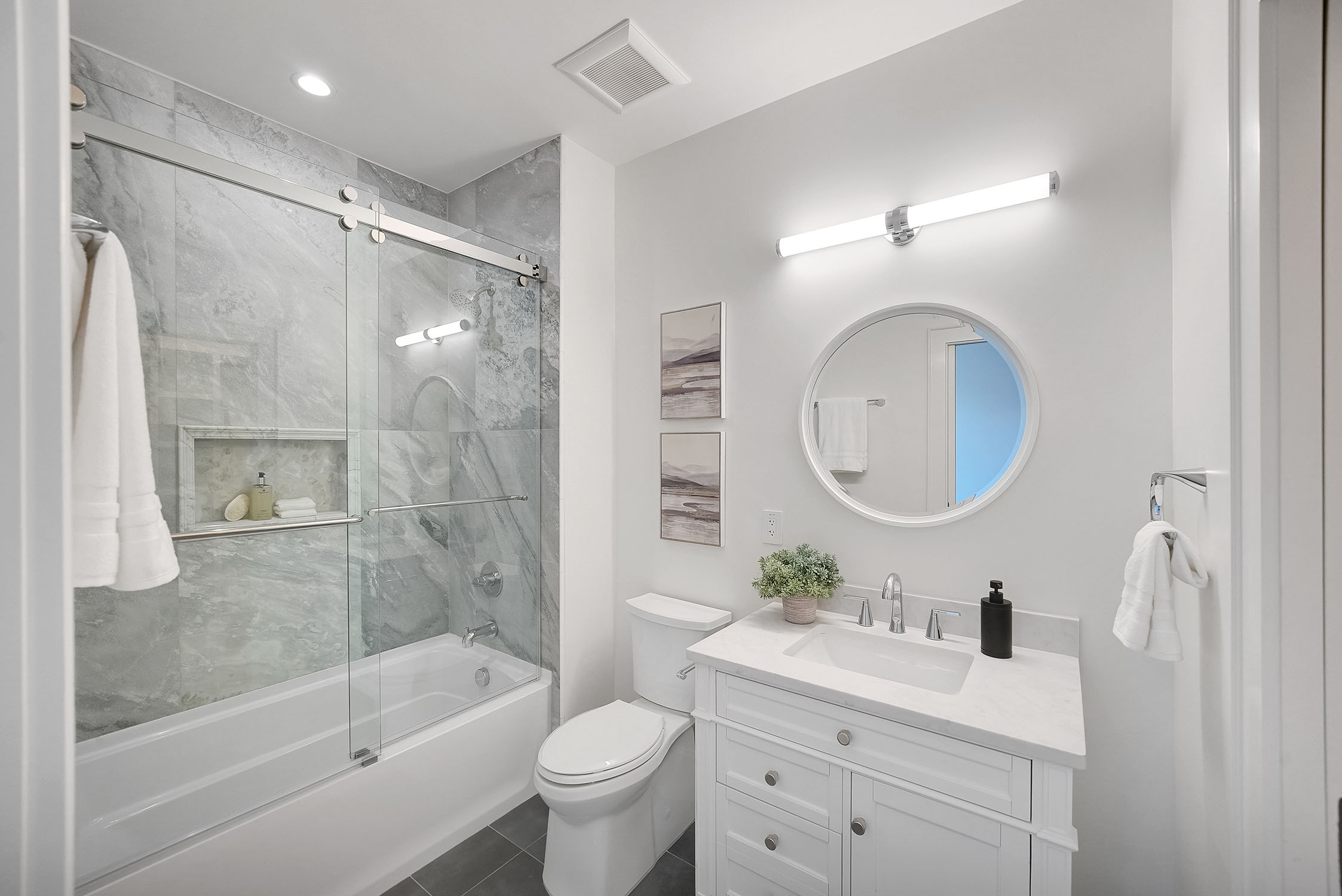 Modern bathroom with glass shower and white vanity