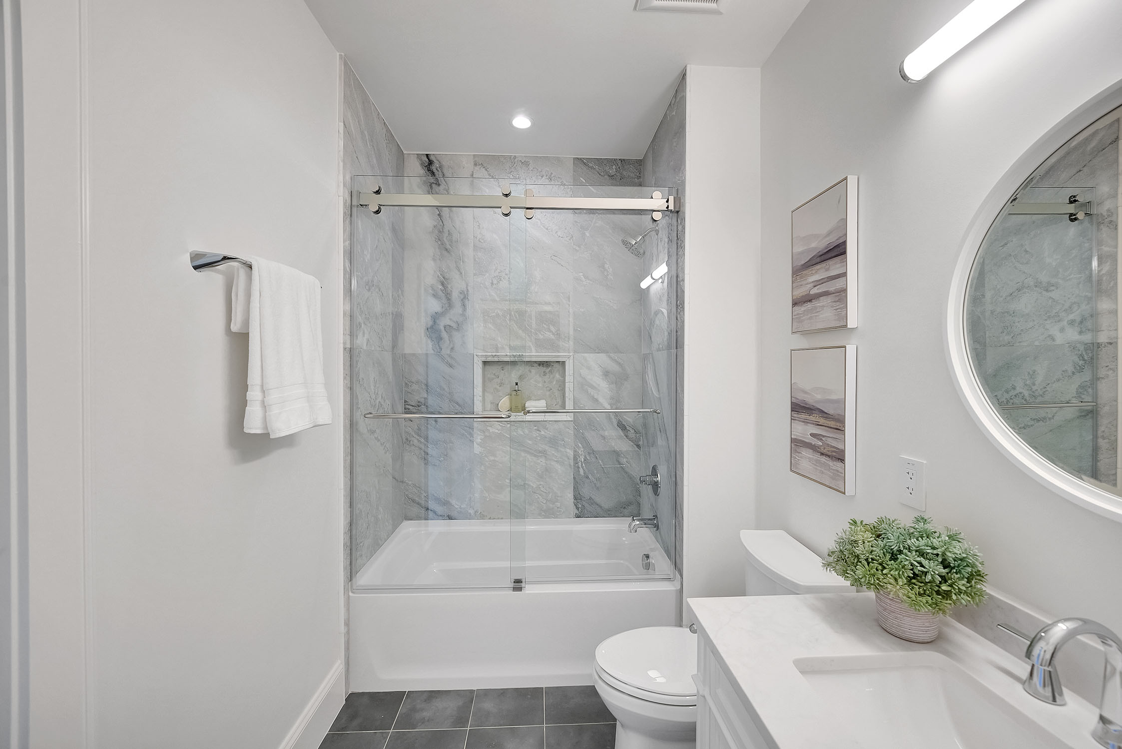 Modern bathroom with glass shower and marble tile