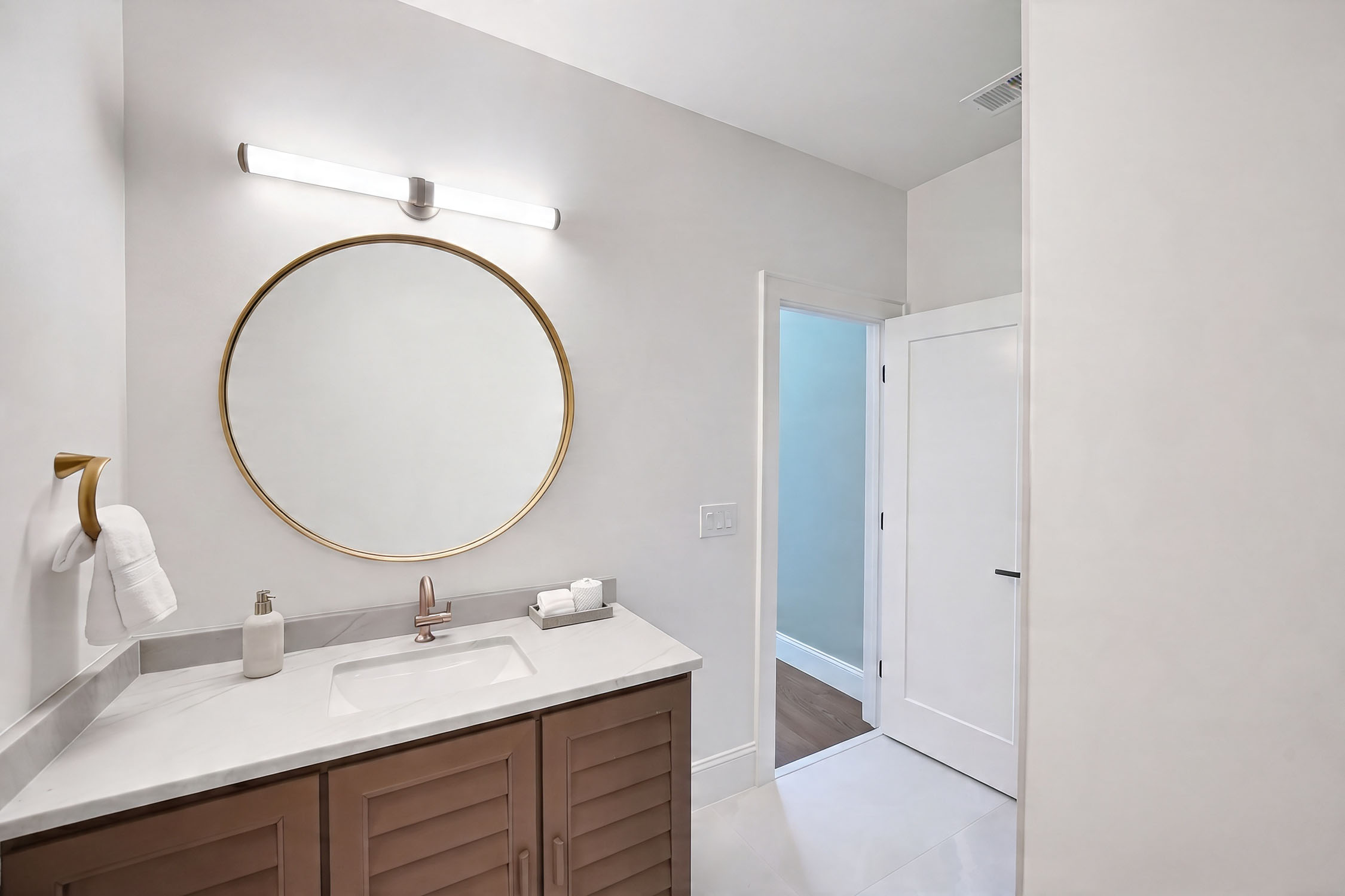 Modern bathroom vanity with round gold mirror
