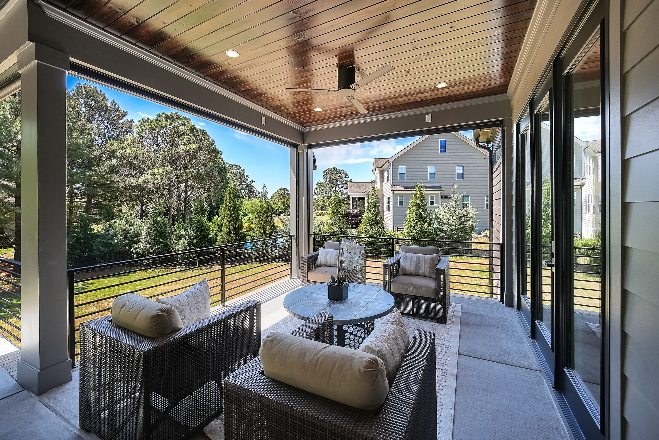 Covered patio with wicker seating and neighborhood view
