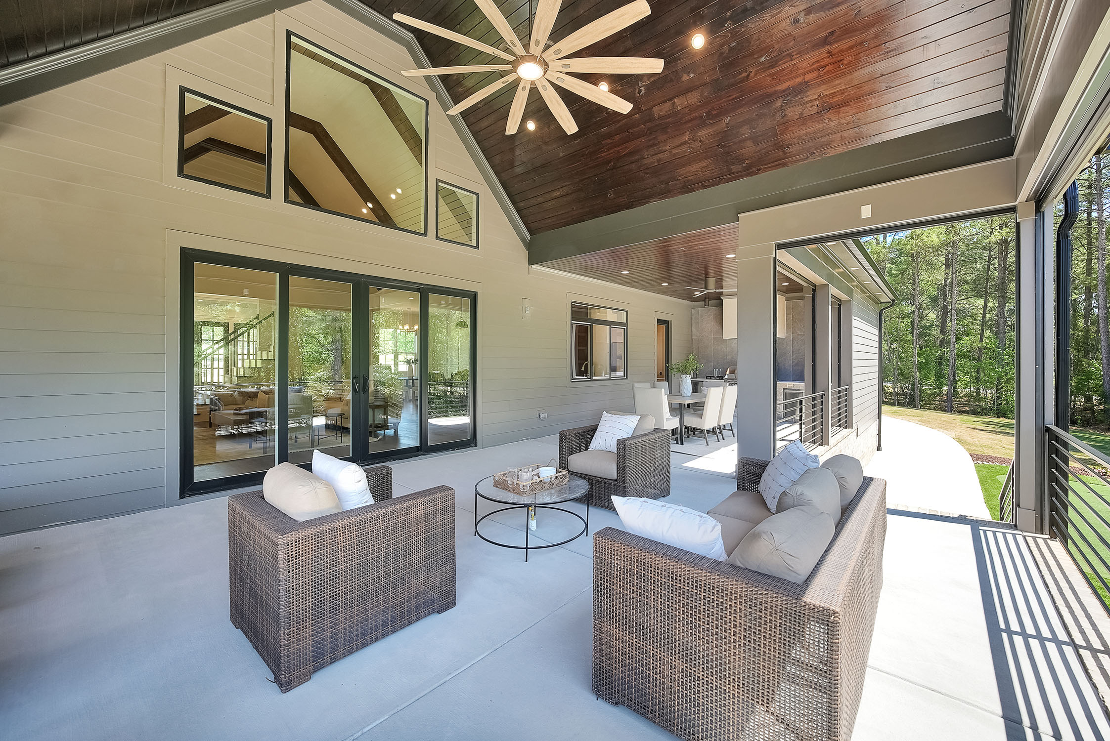 Modern covered patio with wicker seating and ceiling fan