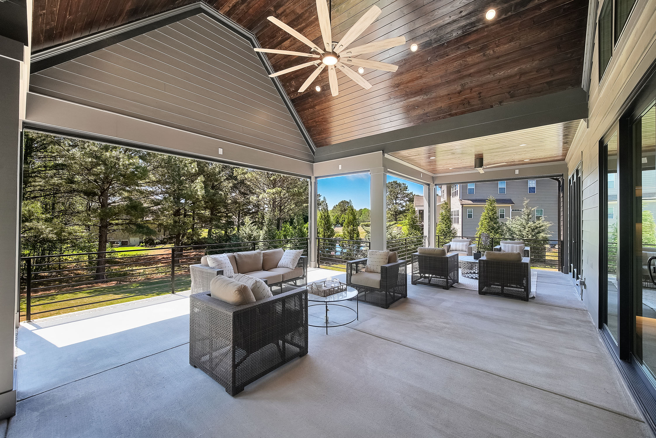 Modern covered patio with outdoor seating and ceiling fan