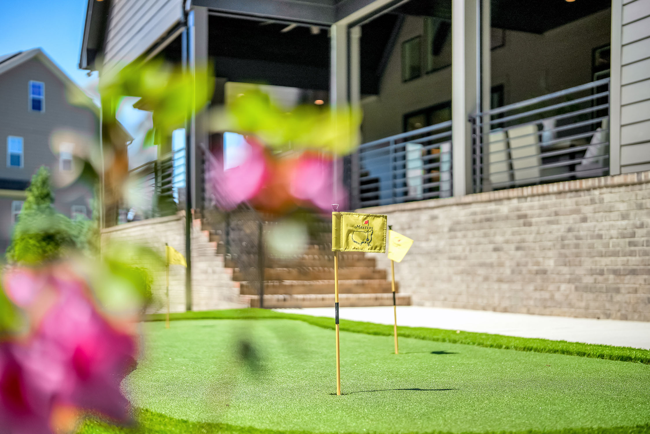 Backyard putting green with Masters flags