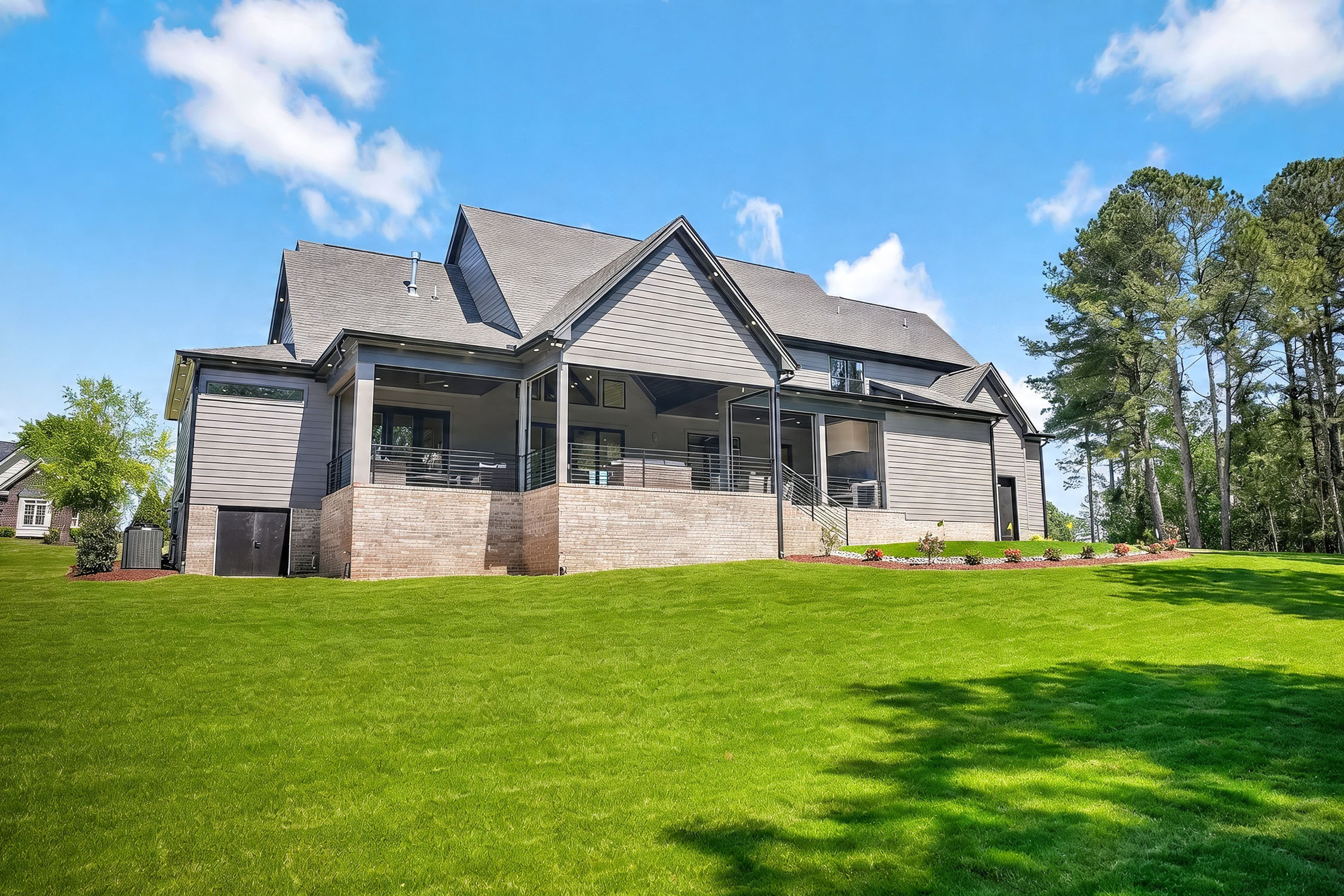 Modern gray house with large backyard lawn