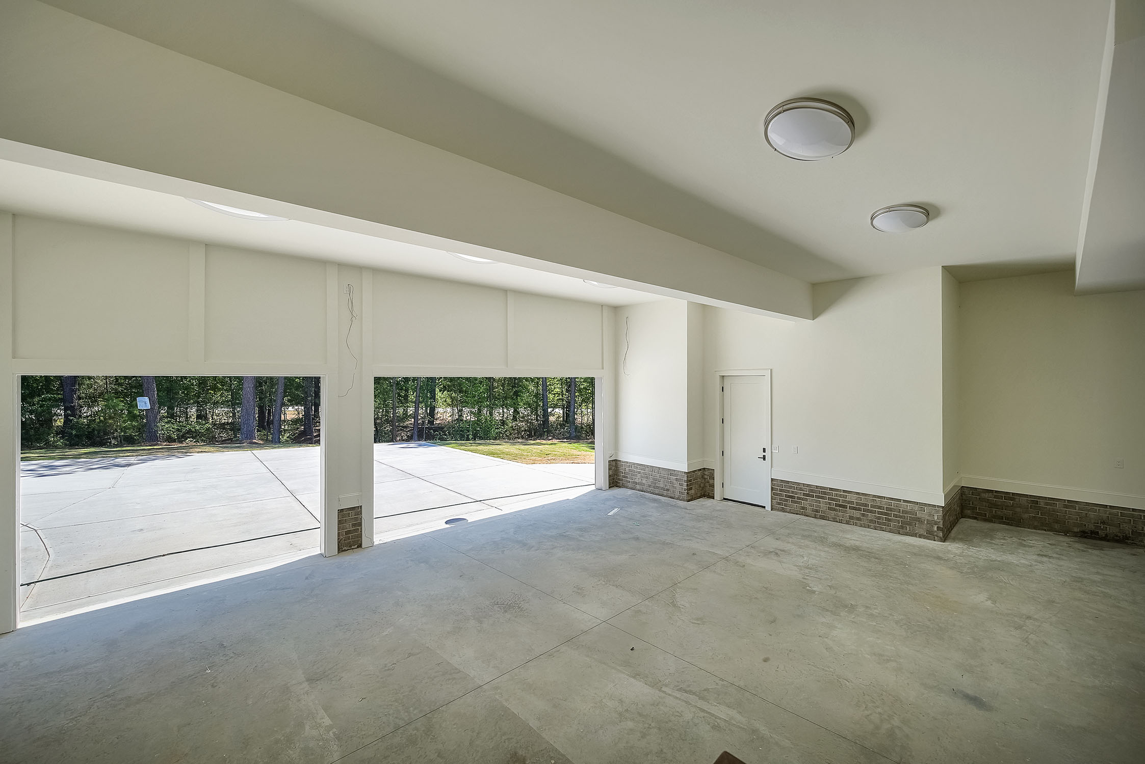 Spacious three-car garage with open doors