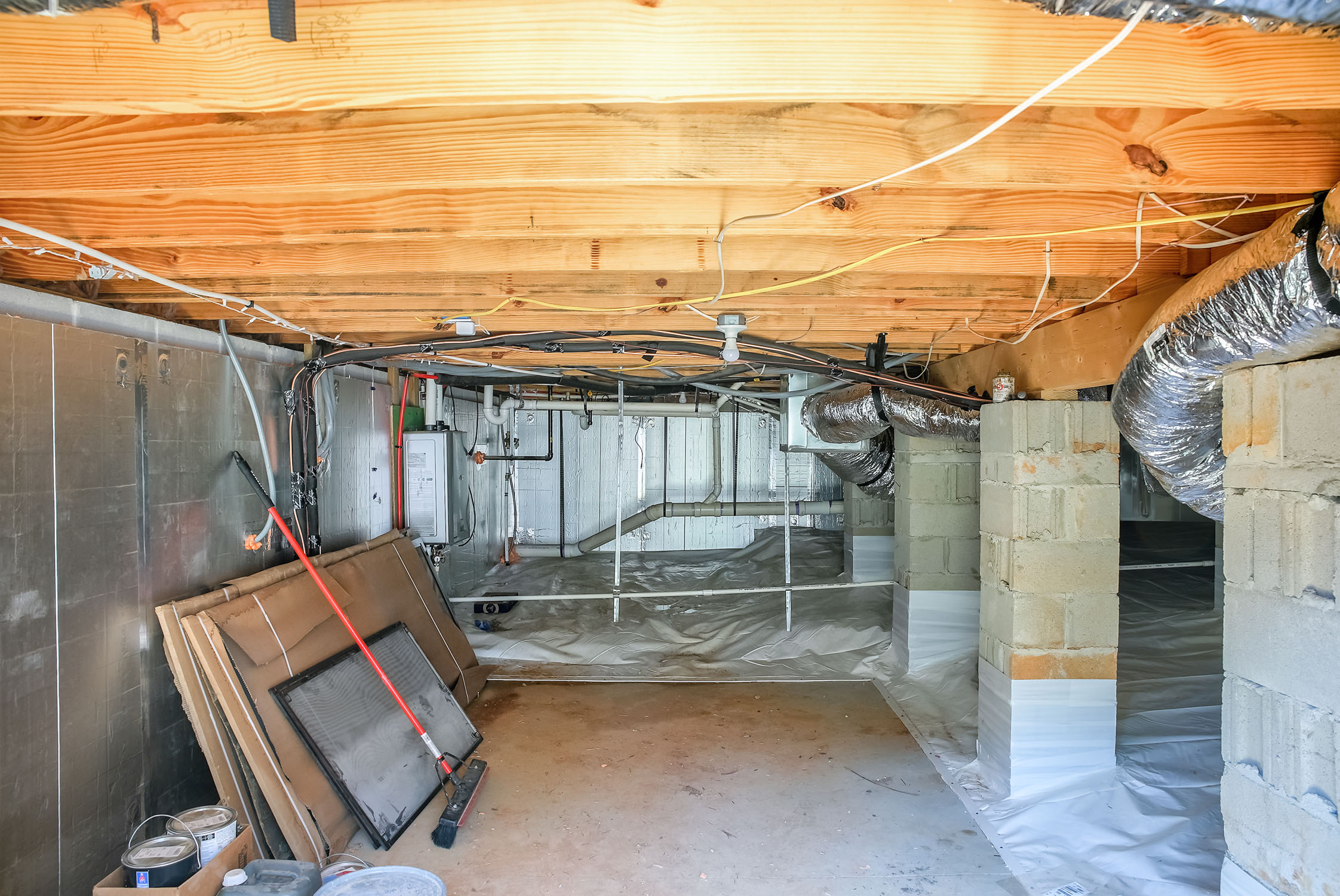Crawl space with exposed beams and ductwork