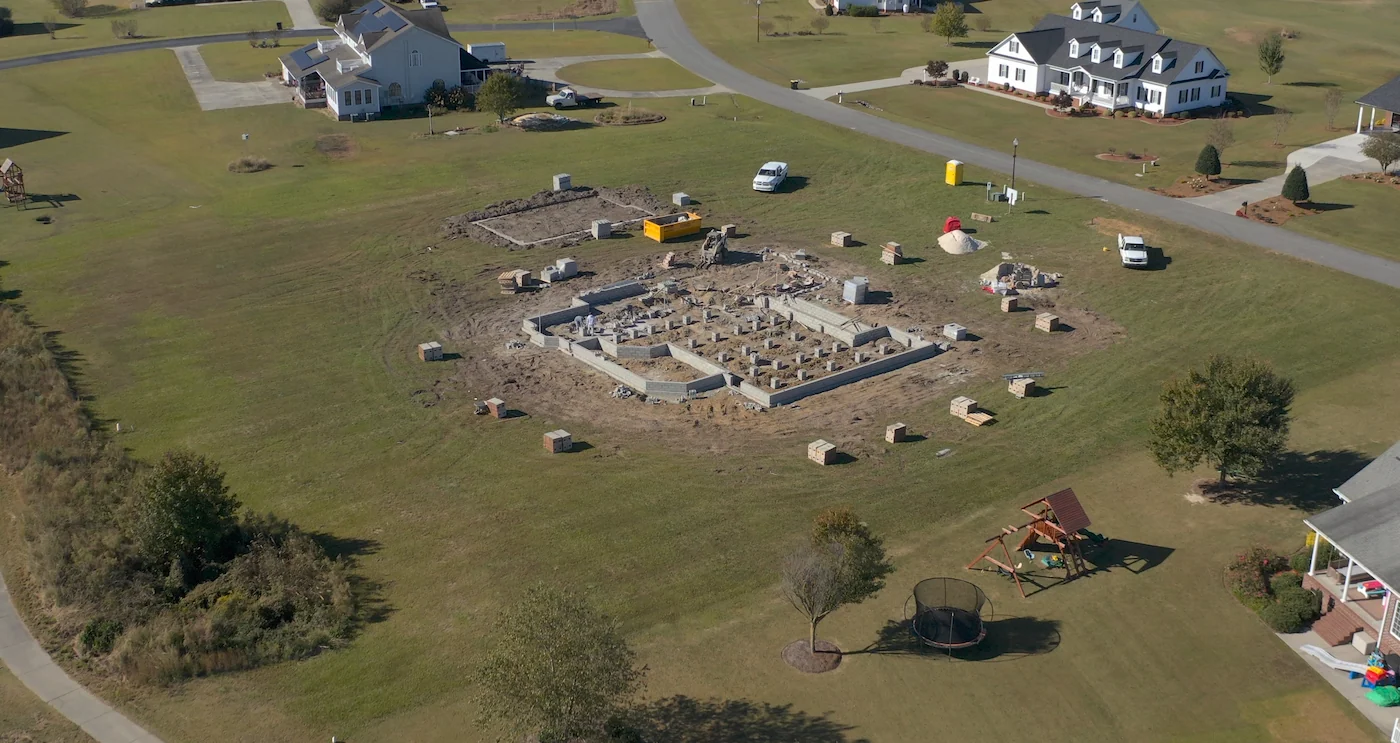 Aerial view of house foundation under construction.