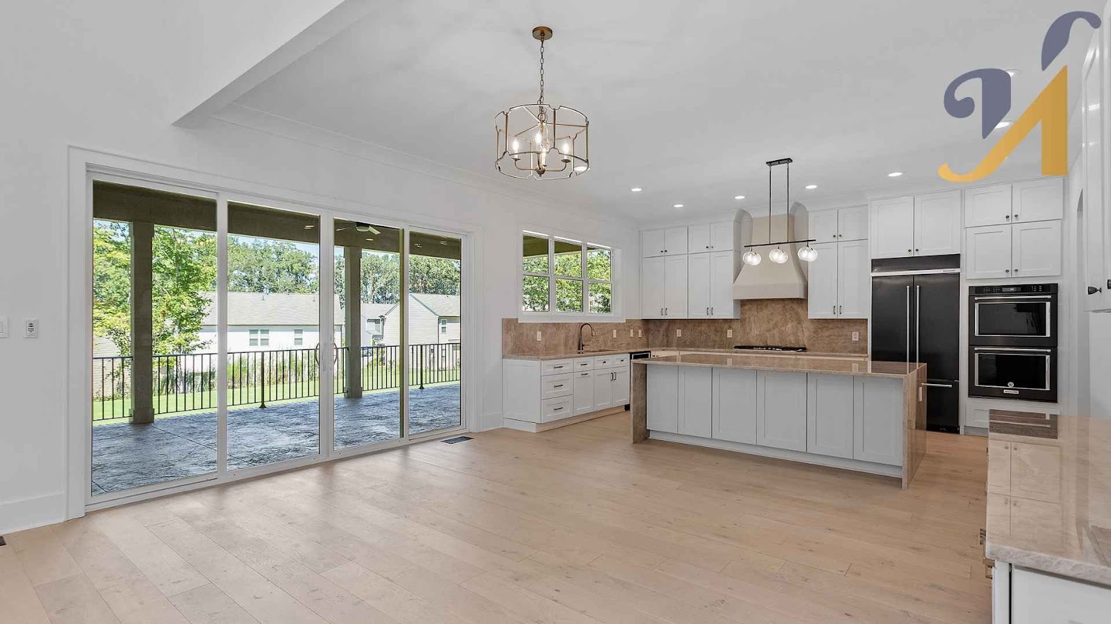 Bright kitchen with energy-efficient lighting and large windows in a smart, eco-friendly custom home.