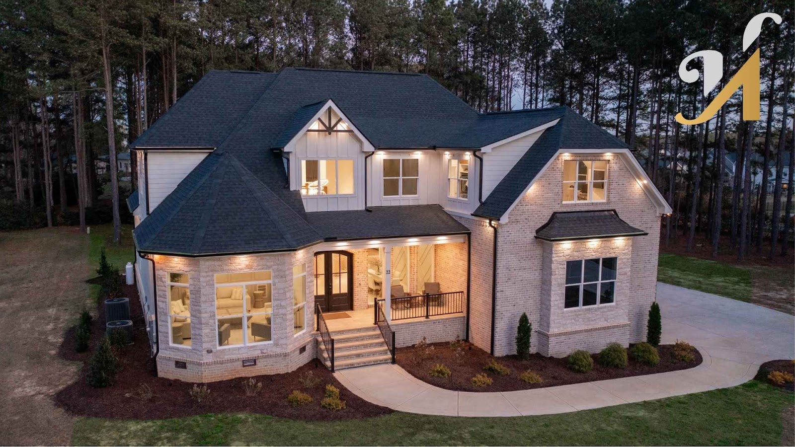 Elegant two-story brick house with outdoor lighting