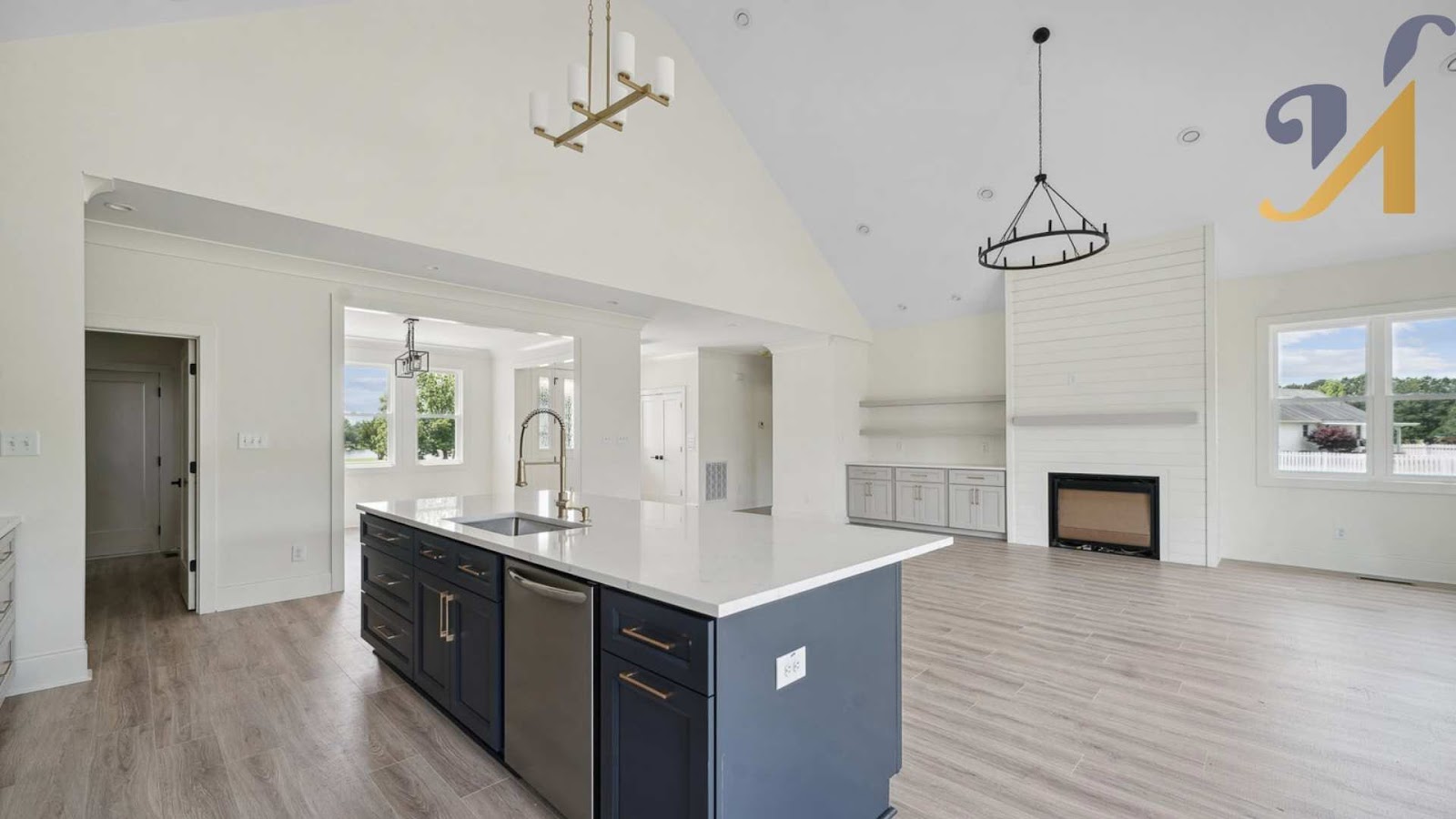 Spacious modern kitchen with island and fireplace.