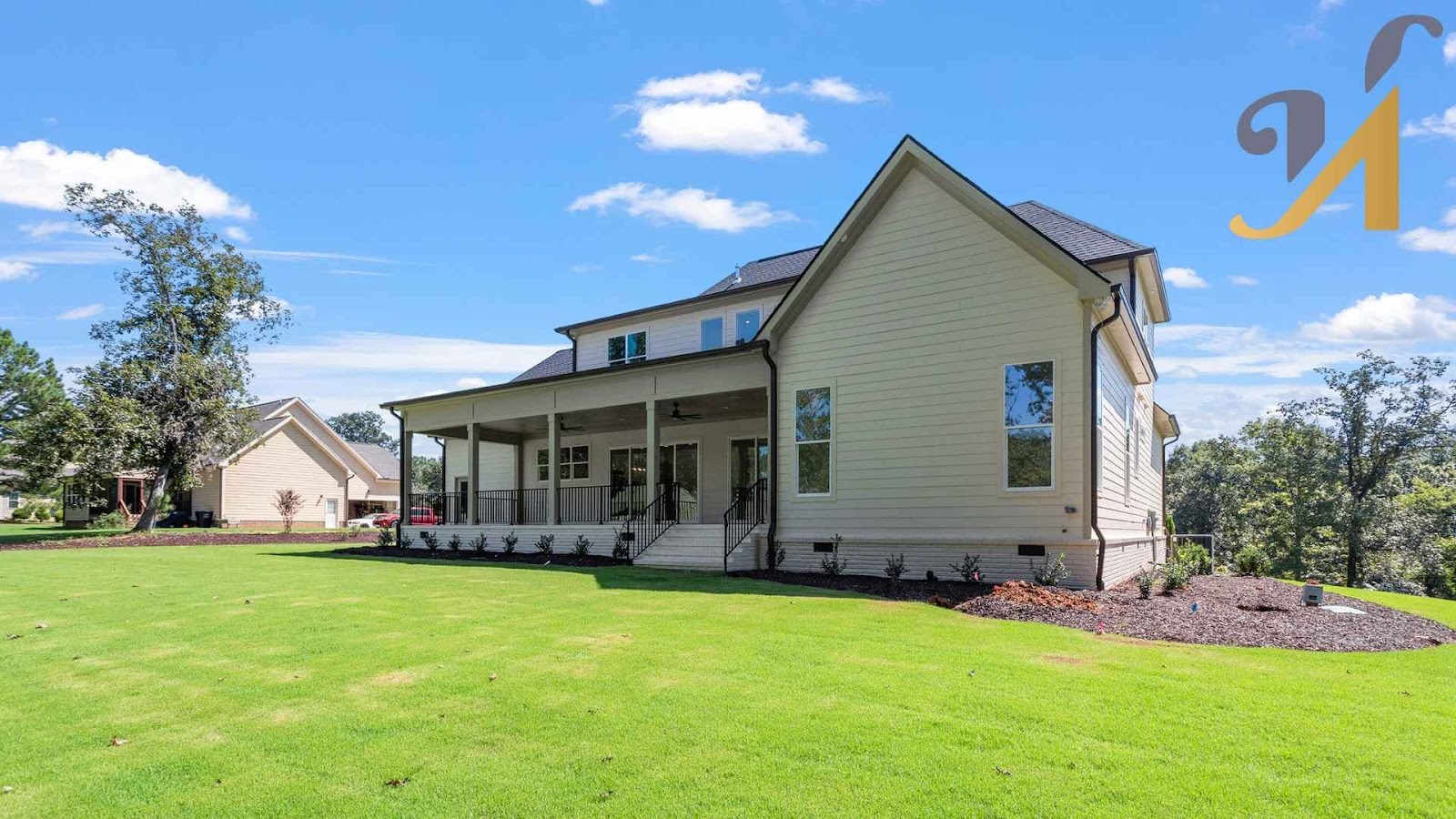 A custom-built home with a wide, open backyard and wraparound porch, designed to fit the land and natural light.