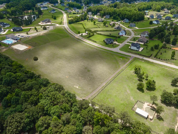 Aerial view of suburban neighborhood and green fields.