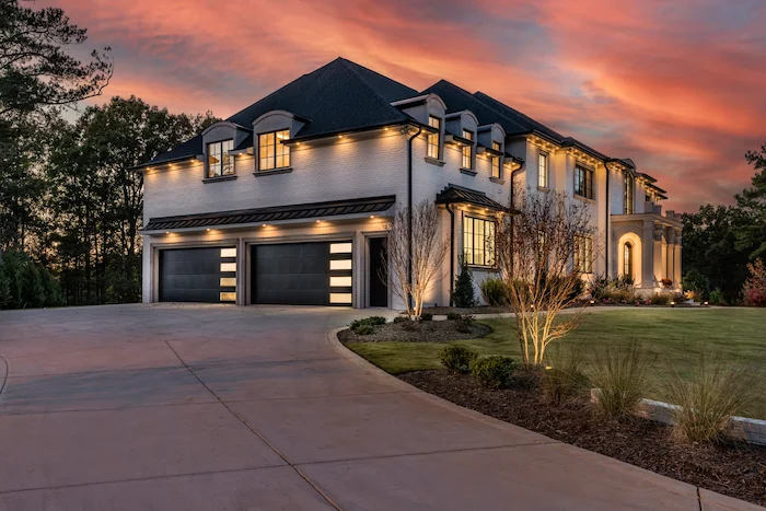 Luxury house at sunset with garage and driveway